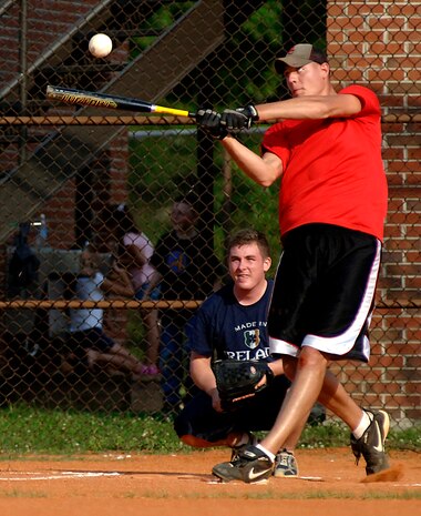 Brent Hillard, 437 APS, puts a smack on the ball as Matt Shields, 437 OSS, watches.(U.S. Air Force photo/Airman 1st Class Nicholas Pilch) 