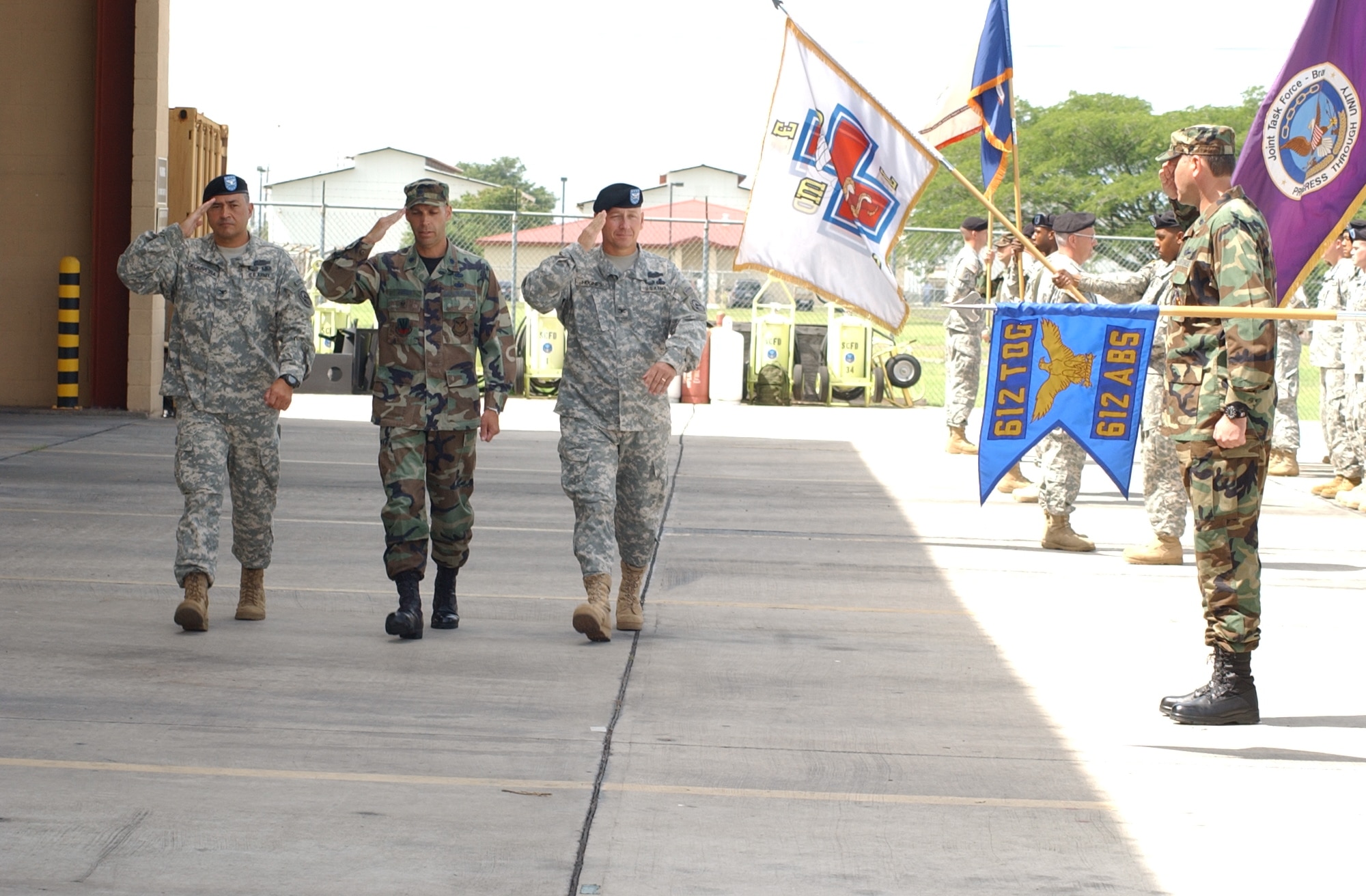 Army Col. Marcus DeOliveira, left, the incoming Joint Task Force-Bravo commander, Lt. Col. Howard Jones, JTF-Bravo deputy commander and Army Col. Christopher Hughes, outgoing JTF-Bravo commander, inspect the troops during the JTF-Bravo change of command ceremony at the Soto Cano Air Base Fire Station June 27. U.S. Air Force photo by Martin Chahin.