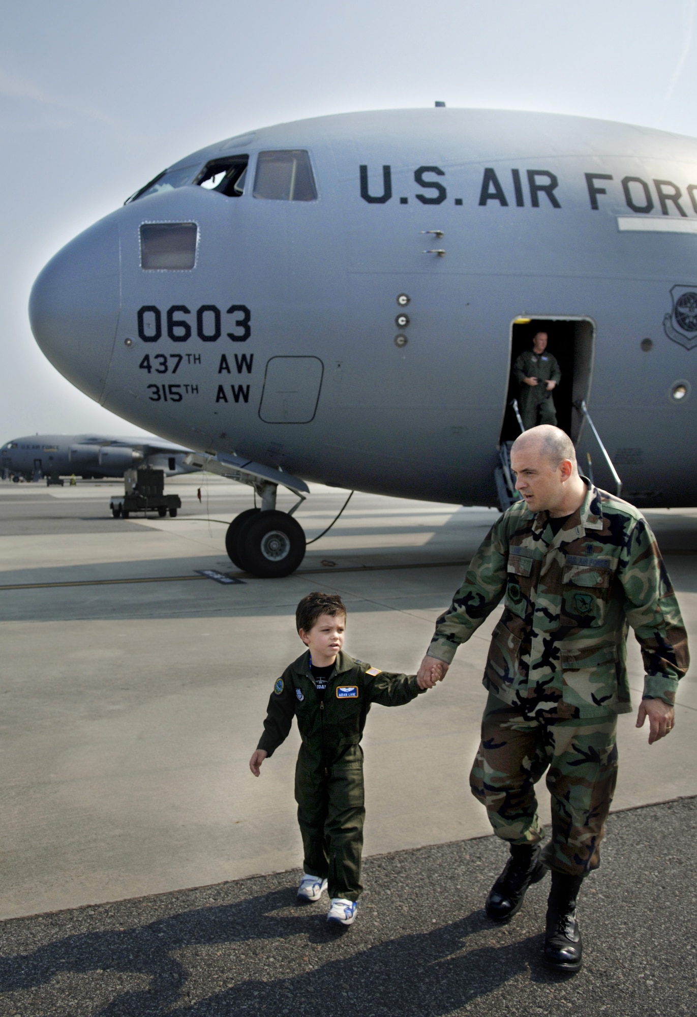 Aiden Lane, 5, son of Maj. Donald and Darii Lane, takes a tour of a Charleston C-17 with his father as part of the Pilot for a Day Program June 19 on the flightline. (U.S. Air Force photo/Airman 1st Class Nicholas Pilch) 
