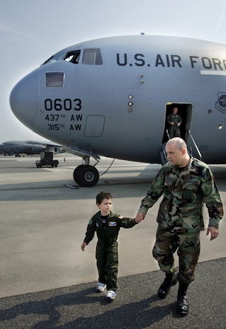 Aiden Lane, 5, son of Maj. Donald and Darii Lane, takes a tour of a Charleston C-17 with his father as part of the Pilot for a Day Program June 19 on the flightline. (U.S. Air Force photo/Airman 1st Class Nicholas Pilch) 