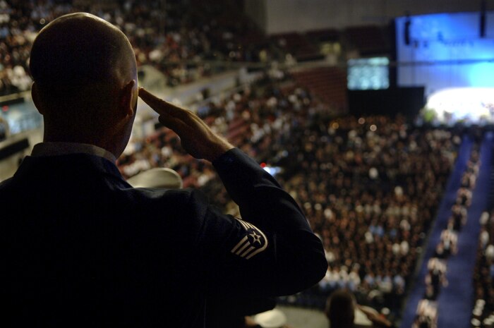 Staff Sgt. Robert McLaughlin, 437th Civil Engineer Squadron firefighter from Charleston Air Force Base, S.C., salutes the caskets of the 9 fallen firefighters from the city of Charleston Fire Department at the memorial service held in their honor at the North Charleston Coliseum June 22.  (U.S. Air Force Photo/Airman 1st Class Nicholas Pilch)