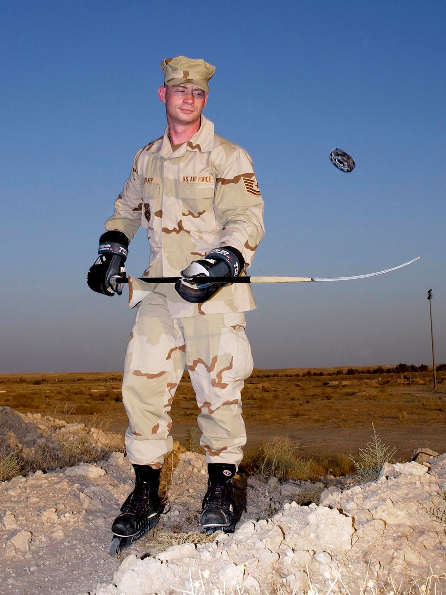 After working a 12-hour shift, Tech. Sgt. Wayland J. Baker is ready to hit the "ice." The father of six is serving a four-month deployment in support of operations Iraqi and Enduring Freedom. After a long day driving vehicles on the hot tarmac he enjoys playing solitaire hockey. The Corinth, N.Y., native deployed from the 116th Logistics Readiness Squadron at Robins Air Force Base, Ga., is assigned to the 386th Expeditionary Logistics Readiness Squadron. (U.S. Air Force photo/Tech. Sgt. Scott Moorman)