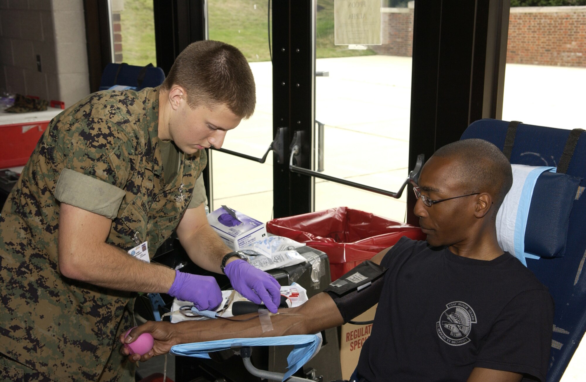 Airman 1st Class Bernard Arthur, U.S. Air Force Honor Guard, donates blood June 25 at the Honor Guard Ceremonial Hall on Bolling. The Armed Services Blood Program holds similar drives four times a week in the National Capital Region. For more information or to donate blood, call ASBP at (703) 681-8024. (U.S. Air Force photo by Airman 1st Class Sean Adams)