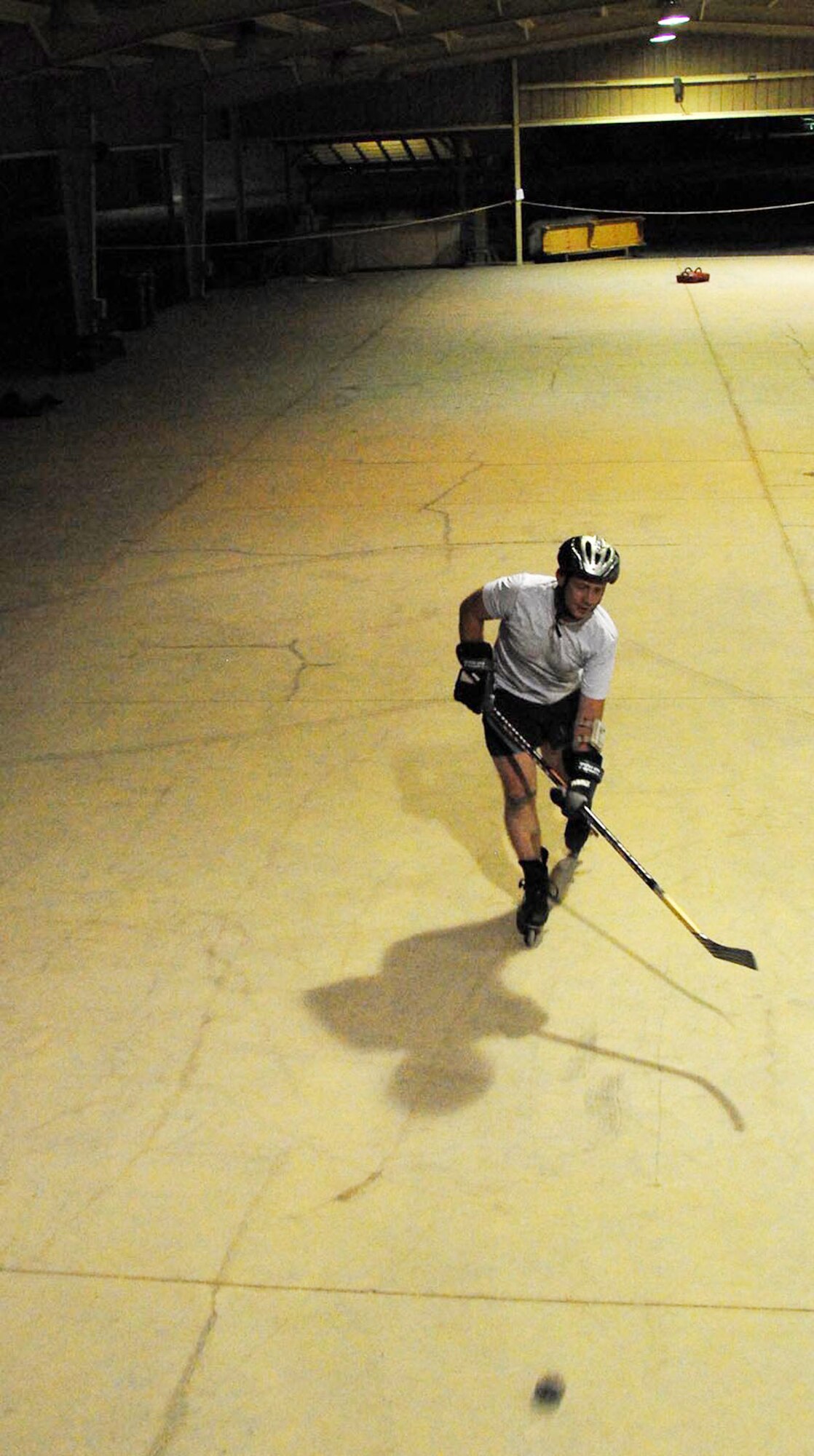 Tech. Sgt. Wayland J. Baker takes his passion for hockey to the Middle East. During his spare time he practices hockey moves in an empty pavilion. Sergeant Baker, is an active duty Air National Guardsman deployed from the 116th Logistics Readiness Squadron, at Robins Air Force Base, Ga., where he serves as NCO in charge of vehicle operations. (U.S. Air Force photo/Senior Airman Andrew Dumboski)