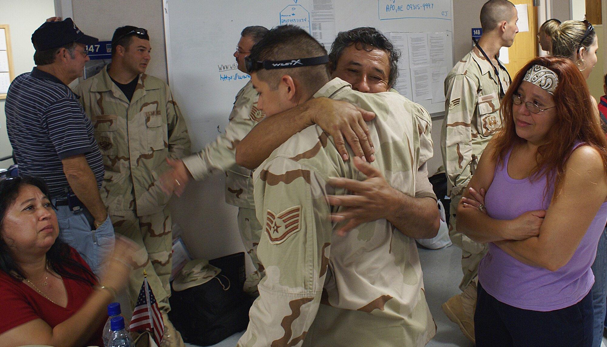 Staff Sergeant “Roberto”, 482nd Aircraft Maintenance Squadron avionics technician, hugs his father, as his mother (sitting-left), and aunt (standing-right), look on. Families of deploying reservists were able to spend the afternoon together June 22 before departing for Southwest Asia. He and about 100 Air Force reservists deployed from Homestead Air Reserve Base, Fla. in support of the Global War on Terrorism. The Airmen deployed as part of a second wave of reservists from the base to support and maintain F-16 fighter jets, which will conduct reconnaissance and close-air-support operations in the region. (U.S. Air Force photo/Dan Galindo)