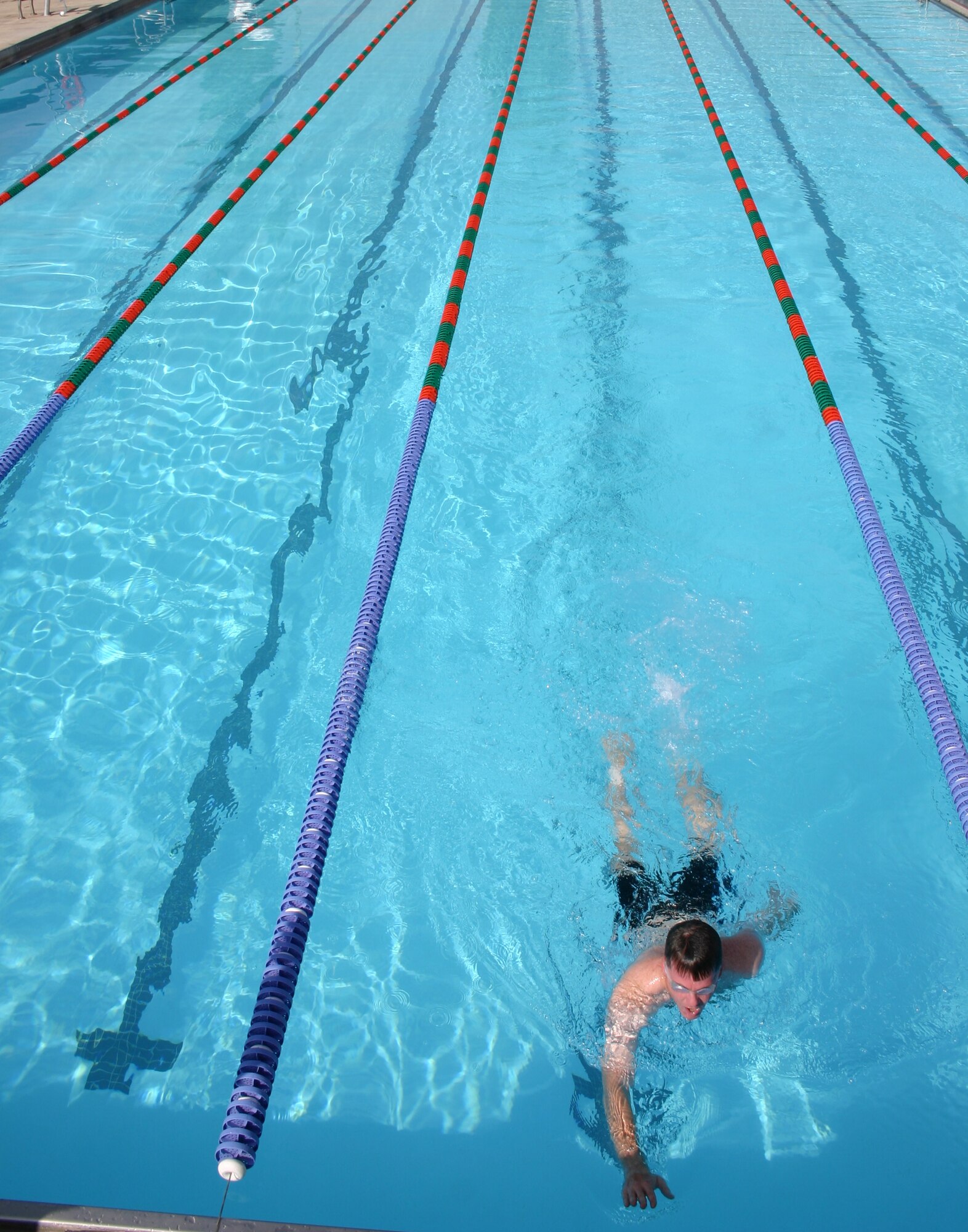 Lt. Col. Brad Kearney, 27th Operations Group, finishes the last stretch of the 500 meter swim during the mini-triathlon held here June 23. Participants swam 500 meters, biked 10 kilometers, and ran five kilometers during the triathlon held by the 27th Services Squadron. (U.S. Air Force photo by Airman Elliott Sprehe)