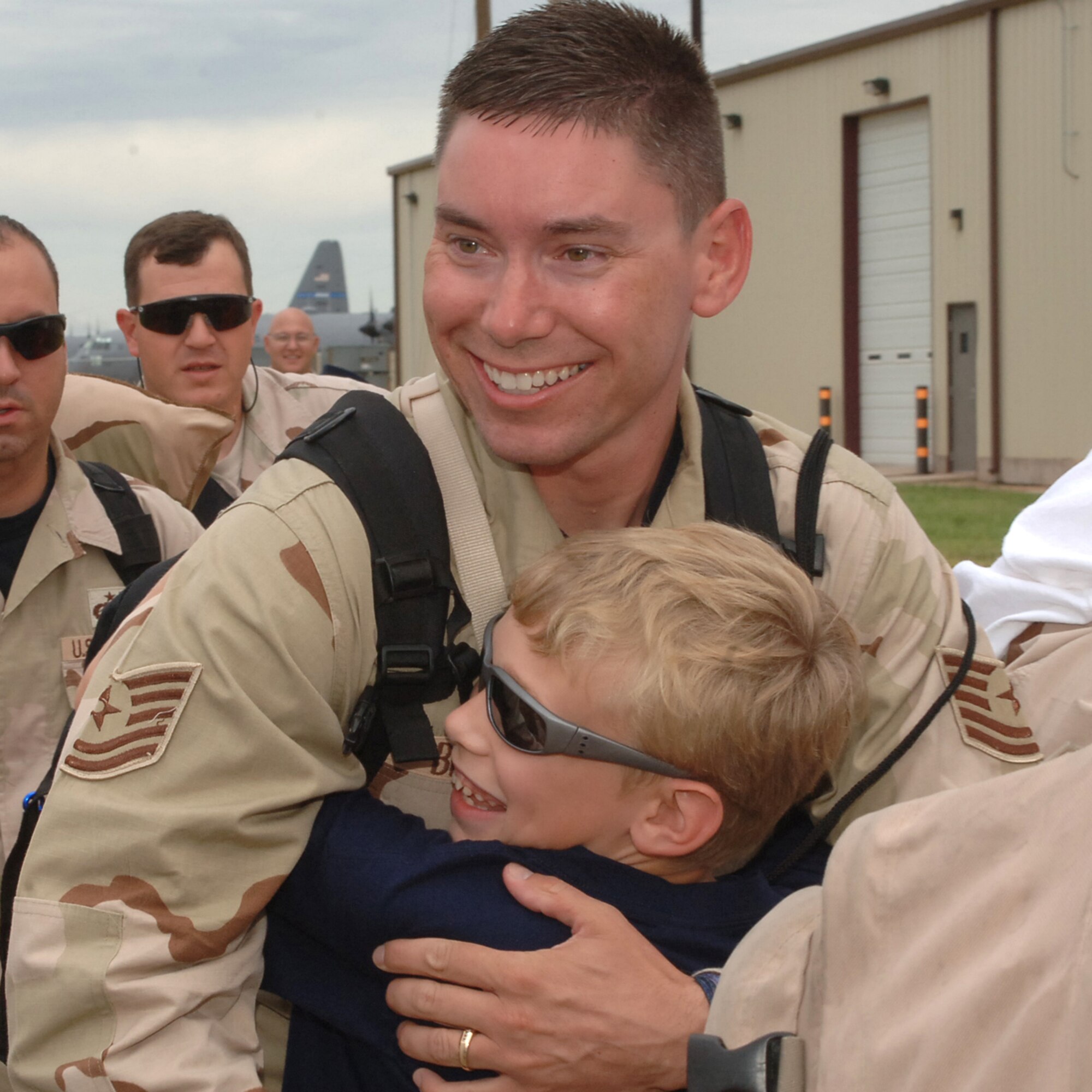 Little Alex Beck welcomes back Tech. Sgt. Brian Beck, 317th Aircraft Maintenance Squadron June 20. Sergeant Beck, along with more than 200 deployed troops, were in Southwest Asia for more than four months supporting Operation Enduring Freedom. (U.S Air Force photo by Airman 1st Class Felicia Juenke)