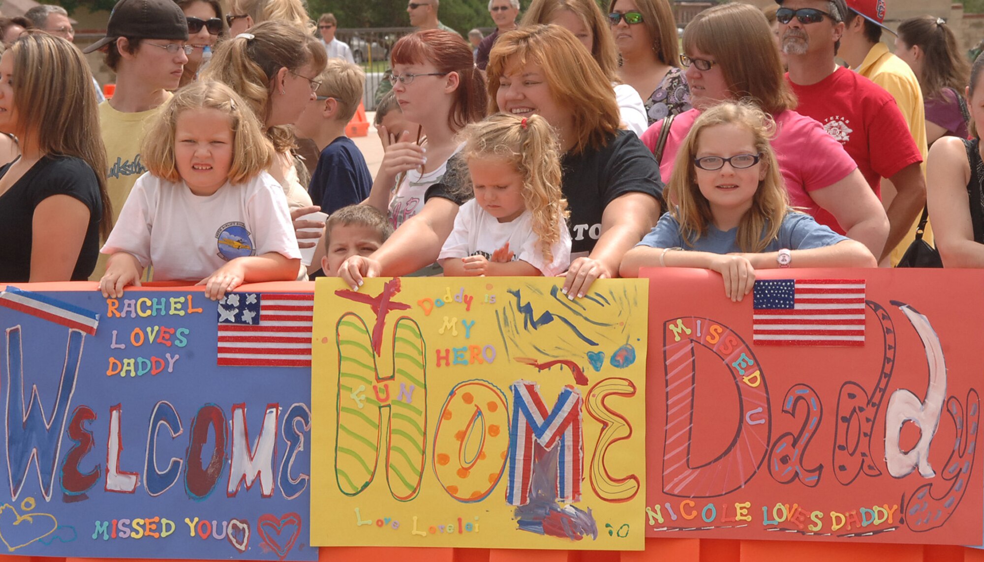 Rose Shirmer and her children Nicole (12), Rachel (7) and Lorelei (3) welcome home Master. Sgt. Rodney Shirmer, 40th Airlift Squadron load master, June 20. Sergeant Shirmer arrived back home after being deployed for more than four months supporting Operation Enduring Freedom. (U.S Air Force photo by Airman 1st Class Felicia Juenke)