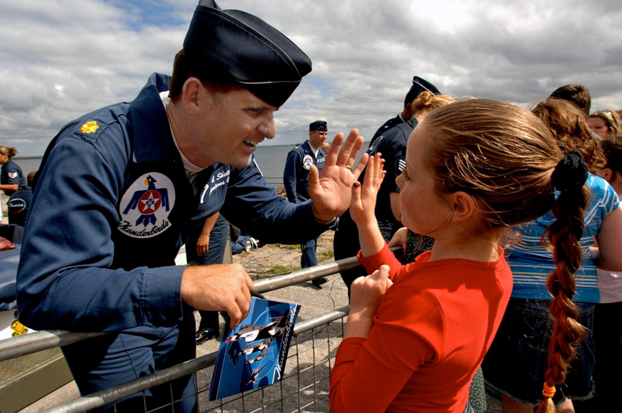 Maj. Rob Skelton, the Air Force Thunderbirds operations officer, greets a young girl at the Salthill Air Show in Galway, Ireland, June 24. This is the first time the Thunderbirds have performed over Irish soil. More than 100,000 people attended the air show, which was the team's first stop on their 2007 European Goodwill Tour. (U.S. Air Force Photo/Tech. Sgt. Justin Pyle) 