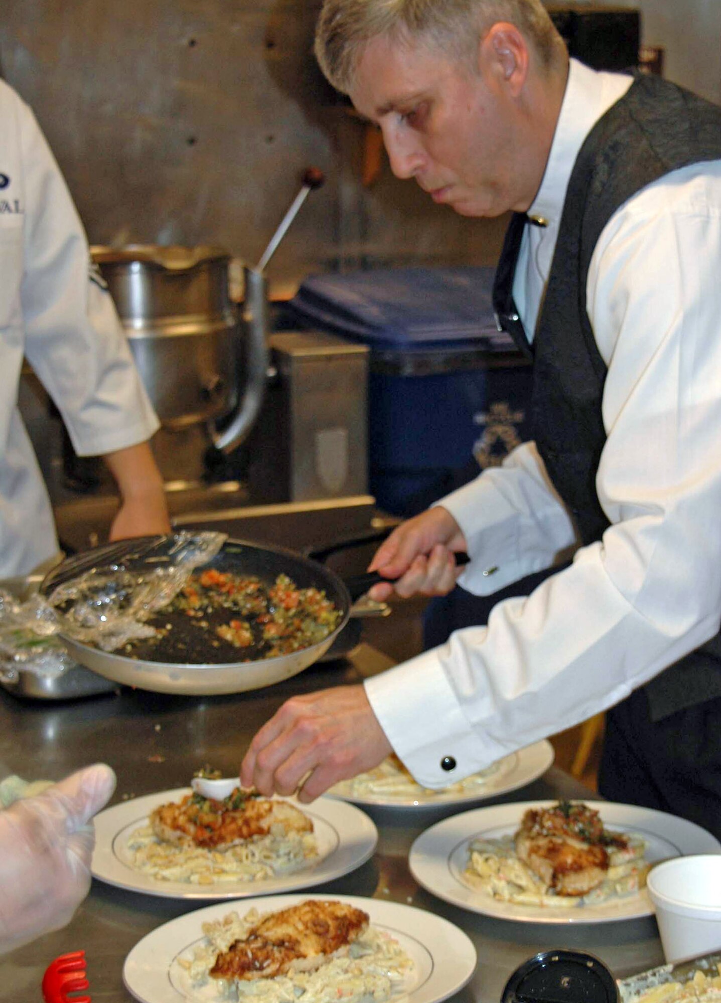 Tech. Sgt. Wesley Williams garnishes a dish at the Bandit Inn at Ellsworth Air Force Base, S.D. Sergeant Williams will be featured on the Food Network's "Emeril Live" June 30 in an episode titled "Emeril's Military Contest." Sergeant Williams is the 28th Services Squadron dining facility manager. (U.S. Air Force photo/Airman Nathan Riley)