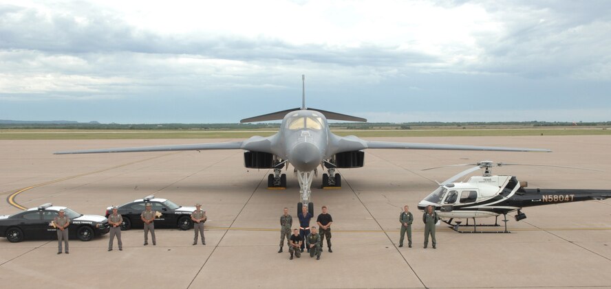 7th Bomb Wing Safety coordinate a unique photo opportunity June 15.  In conjunction with the Texas Department of Public Safety and with help from members of the 7th AMXS, 7th OSS, and 7th CS, they orchestrated some impressive pictures of DPS law enforcement vehicles along side the B-1.  Pictured here with the Bone are two brand-new Dodge Chargers and a DPS helicopter. The finished products will be used by both 7th BW Safety and the Texas DPS for future safety posters, ads, and recruiting publications. (Photo provided by Lt. Col. Darin Defendorf)