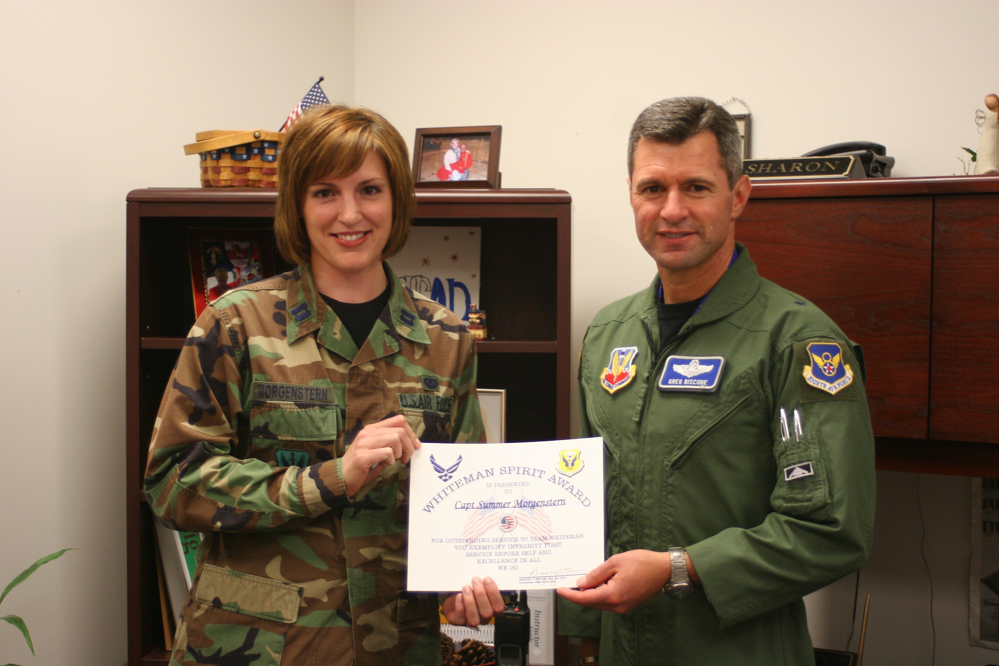 Capt. Summer Morgenstern, 509th Bomb Wing, receives the Whiteman Spirit Award from Brig. Gen. Greg Biscone, 509th Bomb Wing commander, June 4.