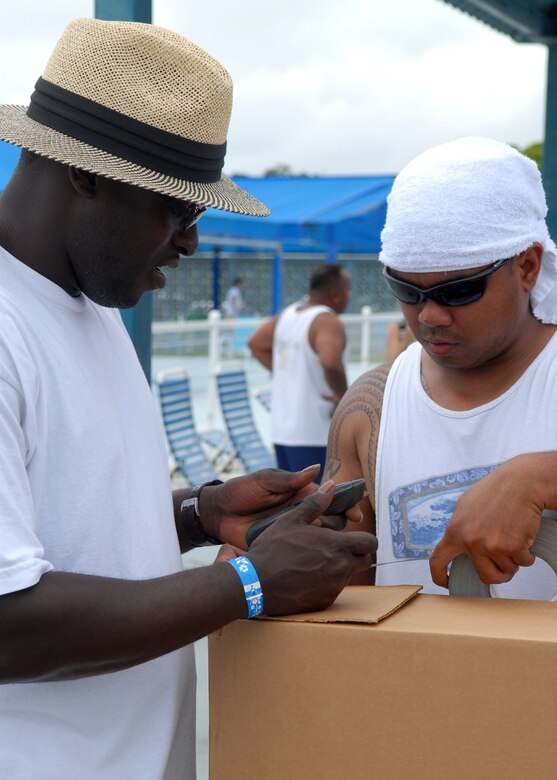 Tech. Sgt. Frederick Smith and Staff Sgt. Nelvin Vinluan tape their raft-style boat before the cardboard boat race begins June 16 at Kadena Air Base, Japan. Sergeant’s Smith and Vinluan are from 18th Logistics Readiness Squadron vehicle maintenance, and were part of team “V’mer Swimmers”.  More than 50 people divided among seven teams competed. Competitors were only supplied with a roll of duct tape, three large pieces of cardboard and a cutting knife.  
U.S. Air Force photo/Senior Airman Jeremy McGuffin