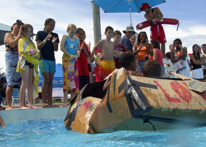 Viewers celebrate as Ryan Yerger, 15, and Miles Swammi, 9, complete the race across the pool for their team, “Great Dragons of Love Circle,” during the cardboard boat race at Hagstrom pool on Kadena Air Base, Japan. More than 50 people divided among seven teams competed in the race June 16. Competitors were only supplied with a roll of duct tape, three large pieces of cardboard and a cutting knife.
U.S. Air Force photo/Senior Airman Jeremy McGuffin