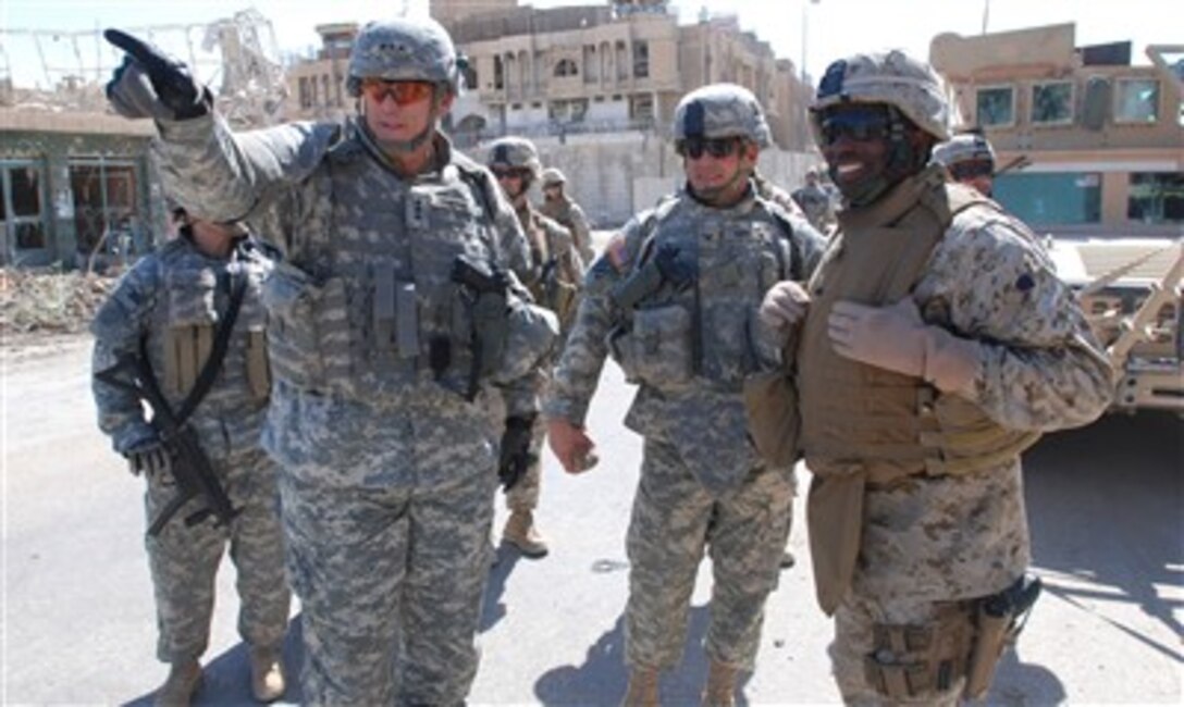 U.S. Army Lt. Gen. Ray Odierno, commander of Multi-National Corps - Iraq, points out a location to Army Col. John Charlton, commander of the 1st Brigade, 3rd Infantry Division, and Marine Corps Maj. Gen. Walter Gaskin, commander of Multi-National Division - West, in downtown Ramadi, Iraq, June 25, 2007. The commanders are touring the city to gauge reconstruction and security operations.