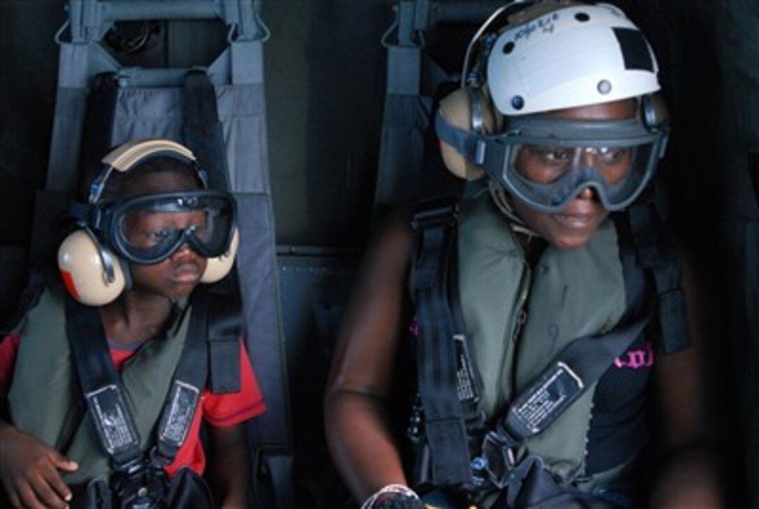 A Belizean woman and her son watch as the U.S. Navy helicopter they are flying in approaches the flight deck of the hospital ship USNS Comfort (T-AH 20) off the coast of Belize on June 22, 2007.  The woman, her son, and several others were flown from Ladyville, Belize, to the ship for medical treatment.   The Military Sealift Command hospital ship is on a four-month humanitarian deployment to Latin America and the Caribbean to provide medical treatment to patients from a dozen countries.  