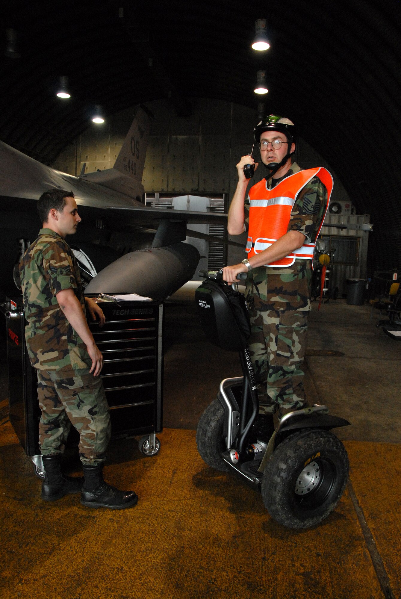 OSAN AIR BASE, Republic of Korea -- Master Sgt. Richard Stratton, 51st Aircraft Maintenance Squadron radios back information from an F-16 Fighting Falcon to the squadron.  Sergeant Stratton is using one of ten new Segway transportation devices aquired by the 51st Fighter Wing in an attempt to streamline the process of preparing aircraft generation.