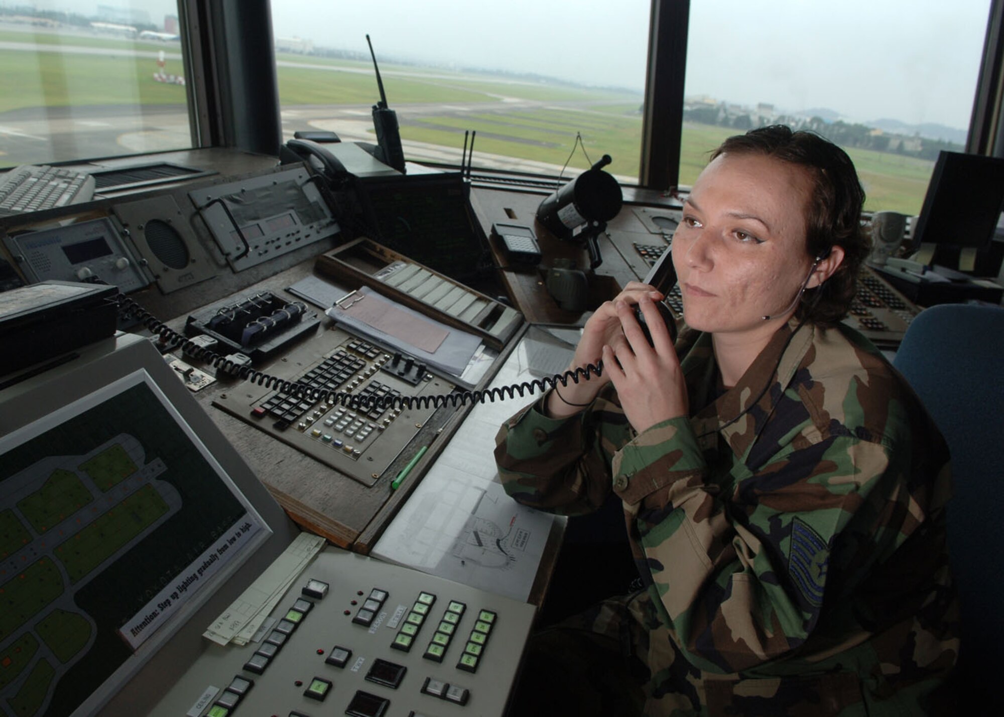 Tech. Sgt. Judy Plummer, 374 Operational Support Squadron, listens to a recording of the ATIS for completeness and accuracy.  The ATIS is a recorded message for the pilots including weather and airport information.  (U.S. Air Force photo by Senior Airman Veronica Pierce)