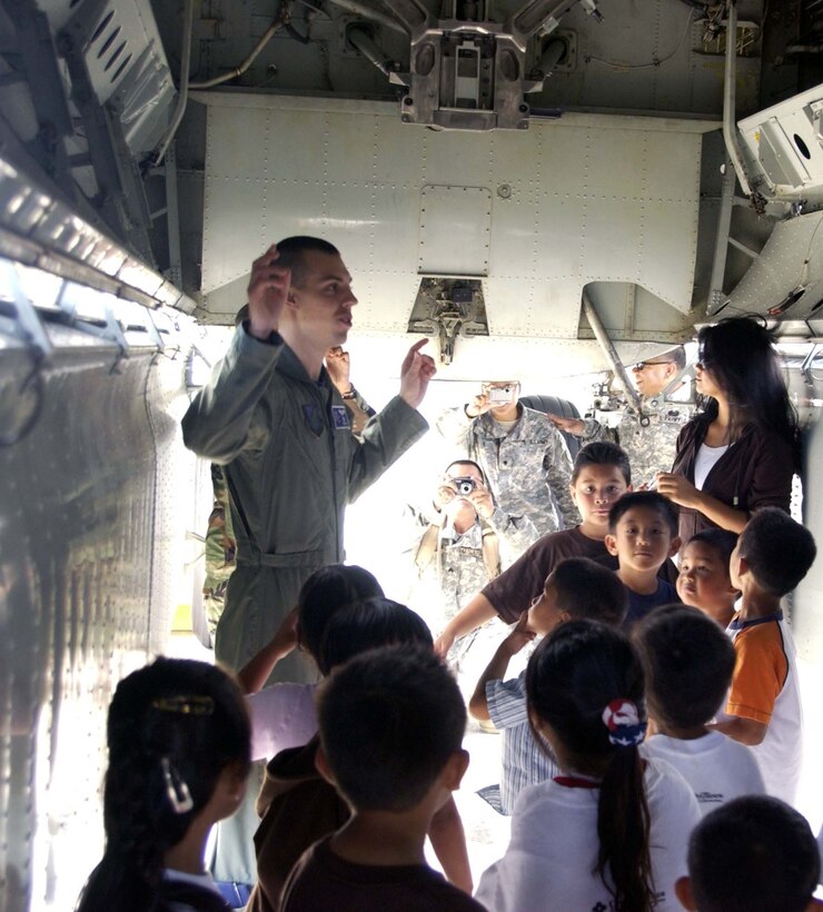Capt. Kenneth Hills, 36th Expeditionary Bomber Squadron, shows children from Camp Freedom the inside of a B-52 June 22. Camp Freedom is a non-profit organization that helps children with deployed parents cope with their parents being gone. (Photo by Master Sgt. Art Webb, 36th EBS)