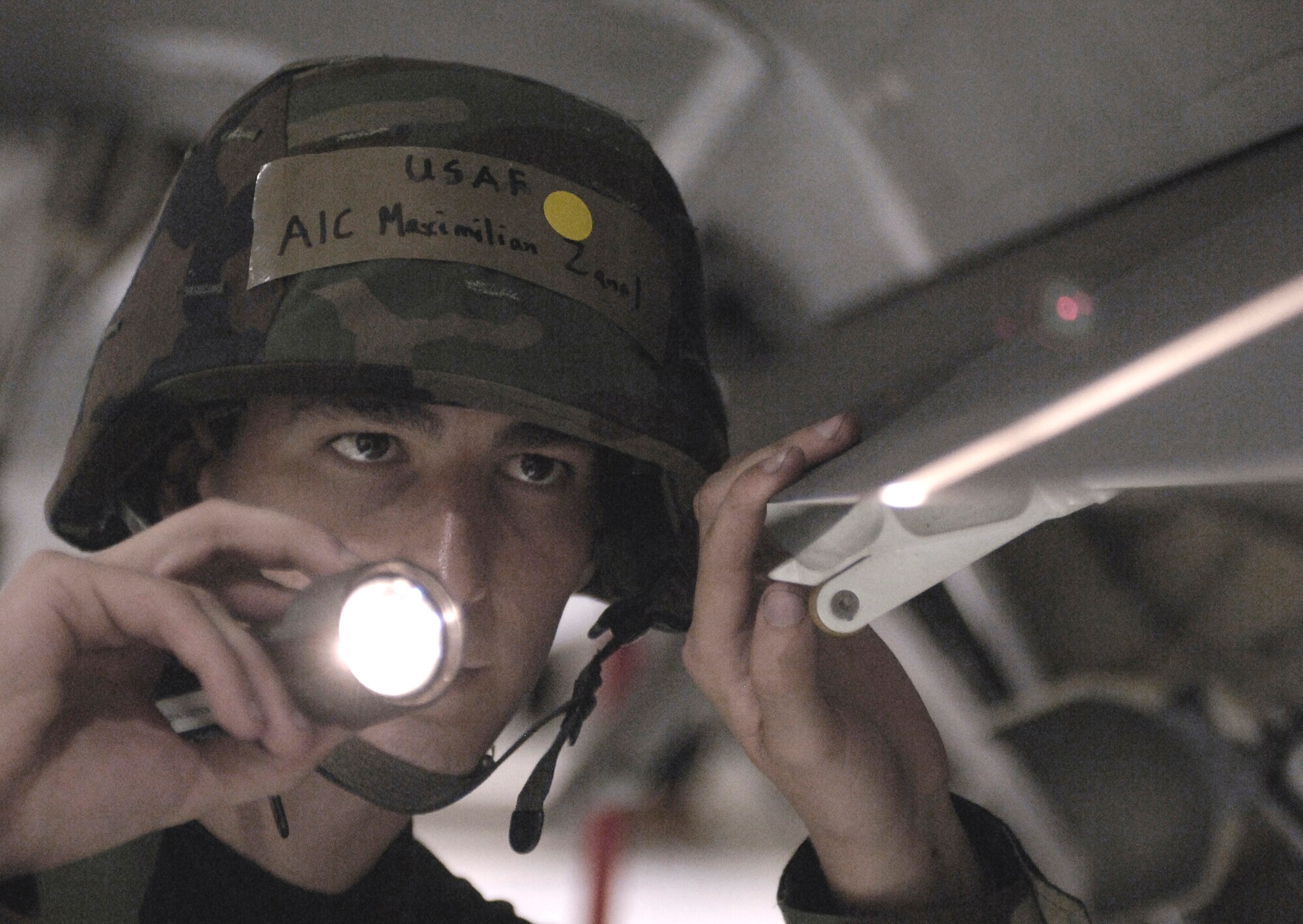 LANGLEY AIR FORCE BASE, Va. -- Airman 1st Class Max Zanol, 1st Equipment Maintenance Squadron, inspects damage to on an F-22A Raptor during a Phase II exercise here June 27.  The 1st Fighter Wing’s Phase II Operational Readiness Exercise is an evaluation of employment, mission support and the ability to survive and operate. (U.S. Air Force photo/Staff Sgt. Austin Knox)  