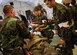 LANGLEY AIR FORCE BASE, Va. -- Staff Sgt. Danielle Diaz, medical technician (center), assists Capts. Jason Feese and James Dahle, physicians from the 1st Medical Operations Squadron, as they treat Airman 1st Class Andrew Nicklow, 1st Civil Engineer Squadron, for simulated chest wounds and internal injuries during a Phase II exercise here June 27. The 1st Fighter Wing’s Phase II Operational Readiness Exercise is an evaluation of employment, mission support and the ability to survive and operate in a combat environment. (U.S. Air Force photo/Staff Sgt. Samuel Rogers)