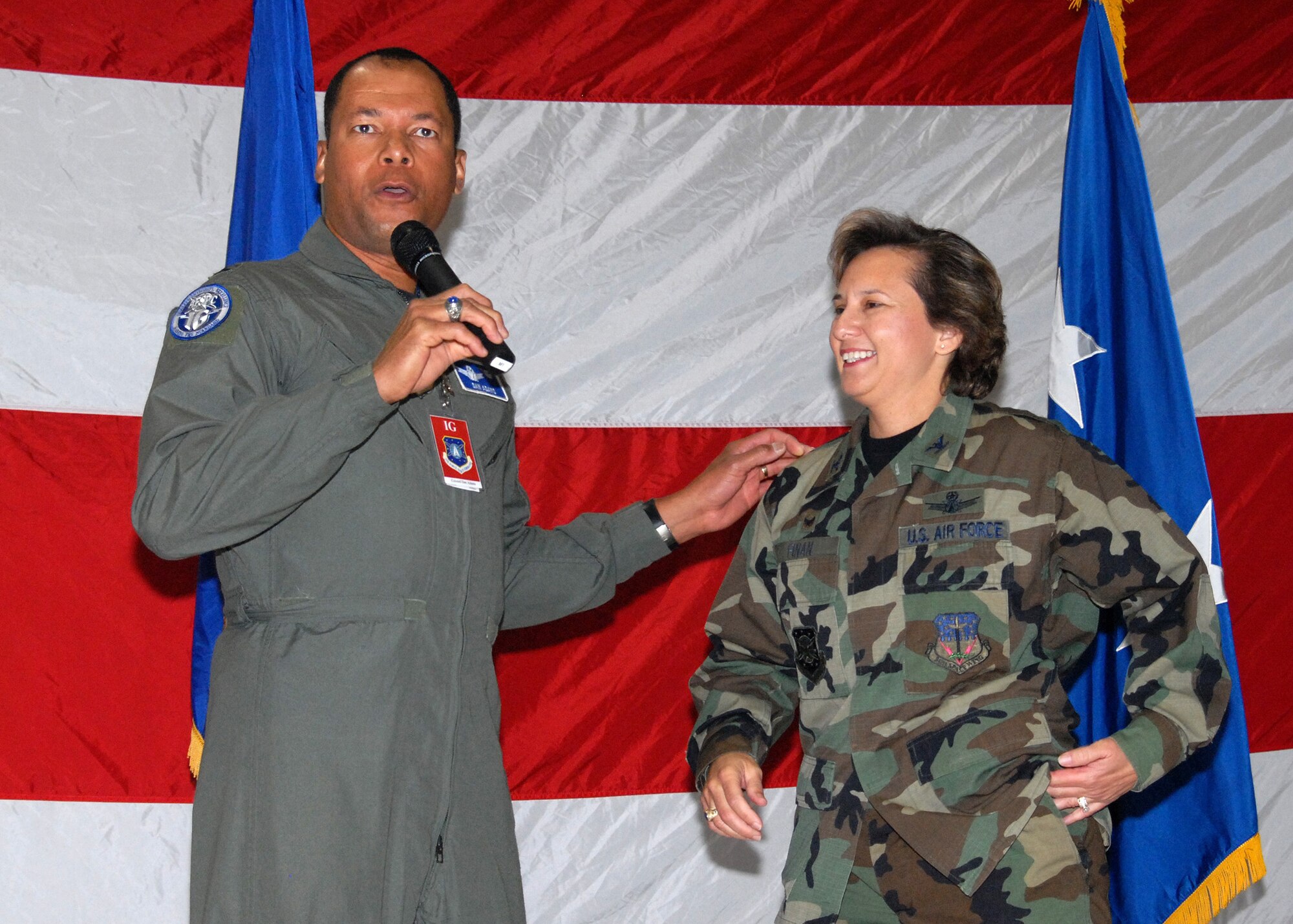 Col. Daniel Adams, Air Force Space Command Insepctor General, congratulates 341st Space Wing Commander Col. Sandy Finan during the outbrief June 25. He credited the impressive inspection results directly to her leadership.