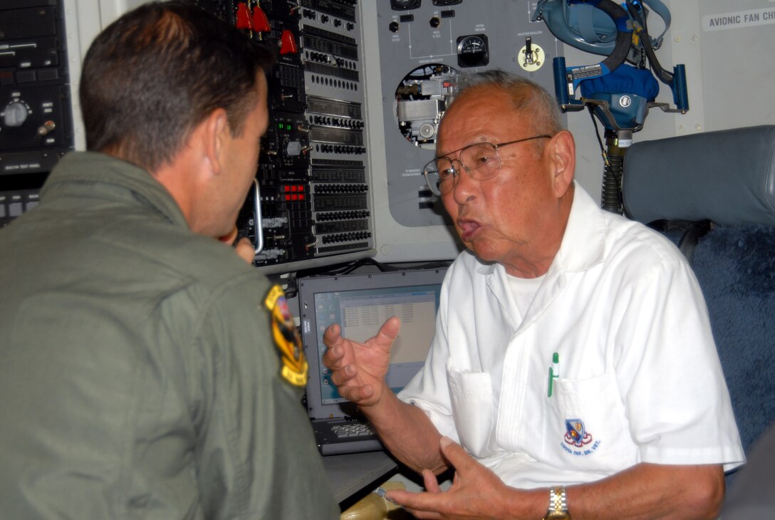 Senior Master Sgt. Darrin Morris talks with World War II veteran Sam Fujikawa during a visit to a C-17 Globemaster III June 25 at Hickam Air Force Base, Hawaii.  Mr. Fujikawa and other members of the 100th Infantry Battalion were touring the base.  Sergeant Morris is a loadmaster with the Hawaii Air National Guard's 154th Wing.  (U.S. Air Force photo/Master Sgt. Kristen M. Higgins)