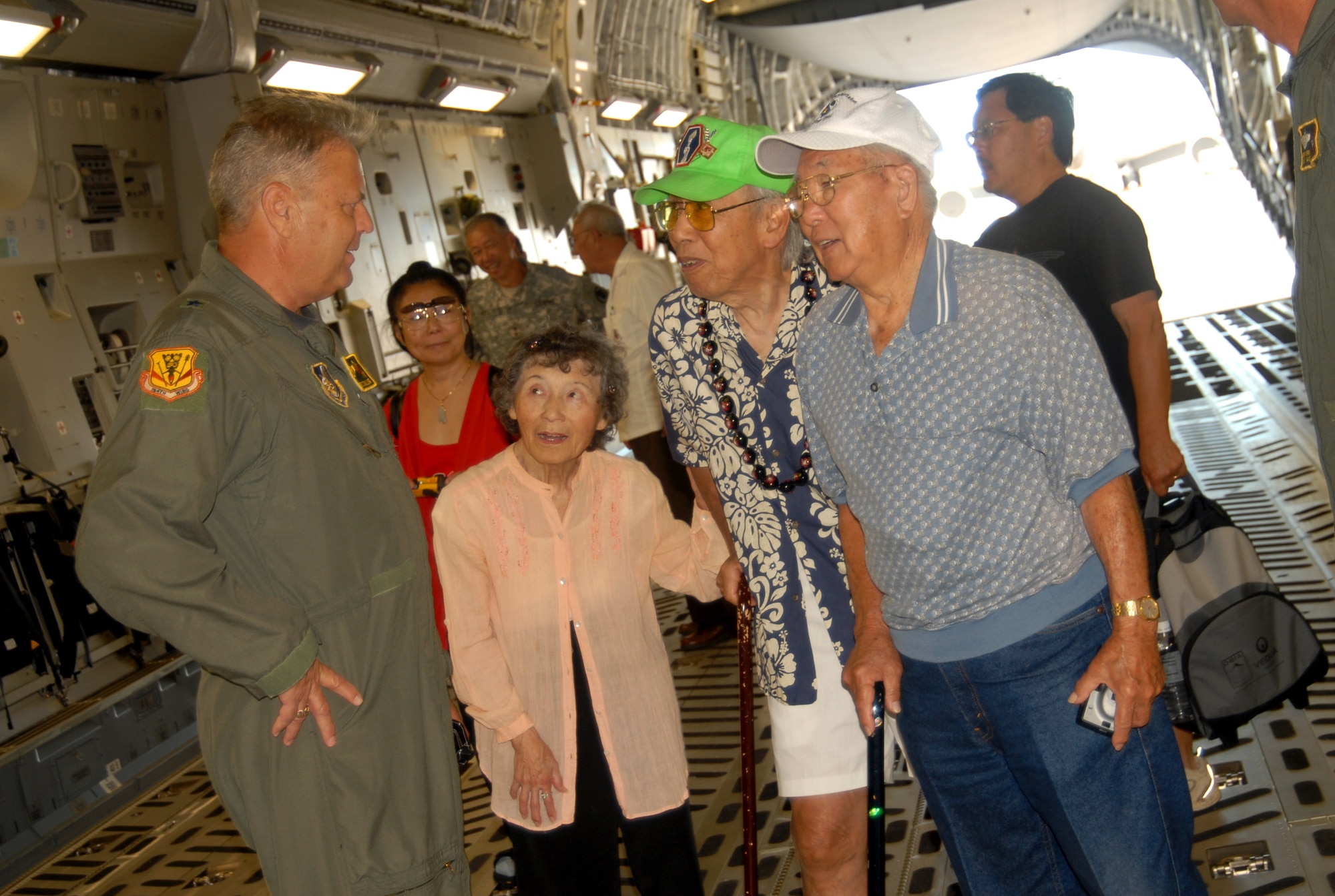 Brig. Gen. Peter Pawling talks with veterans visiting a C-17 Globemaster III June 25 at Hickam Air Force Base, Hawaii.  The veterans, who served in the 100th Infantry Battalion during World War II, and family members were taking a tour of the base.  General Pawling is the commander of the Hawaii Air National Guard's 154th Wing.  (U.S. Air Force photo/Master Sgt. Kristen M. Higgins) 