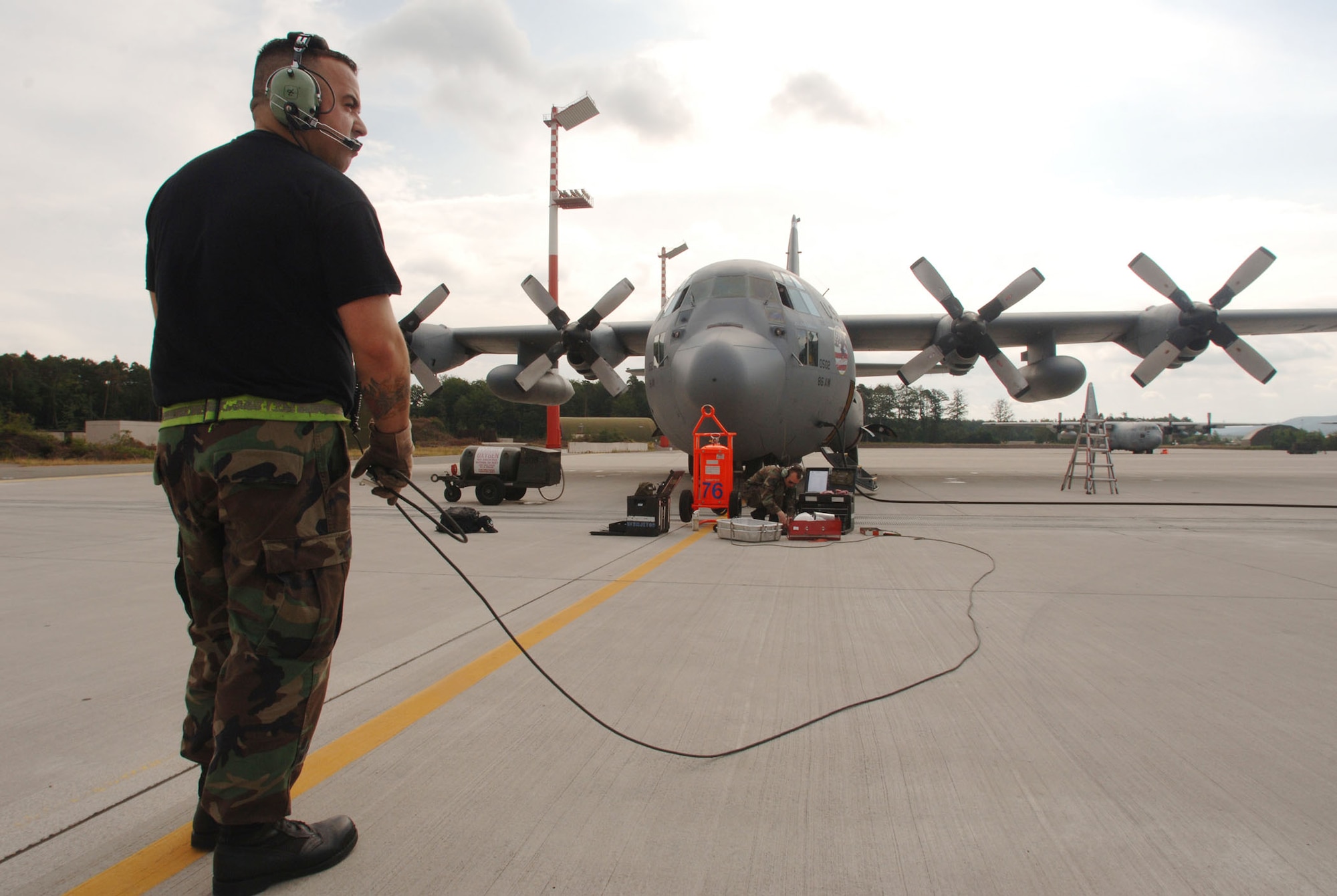 Staff Sgt. Devon Bullock performs pre-flight checks on a 47-year-old C-130 Hercules June 25 at Ramstein Air Base, Germany. The 47-year-old plane will soon represent the 86th Airlift Wing in the 2007 Air Mobility Command Rodeo at McChord Air Force Base, Wash. Sergeant Bullock is a C-130 crew chief assigned to the 86th Aircraft Maintenance Squadron. (U.S. Air Force photo/Master Sgt. Scott Wagers)