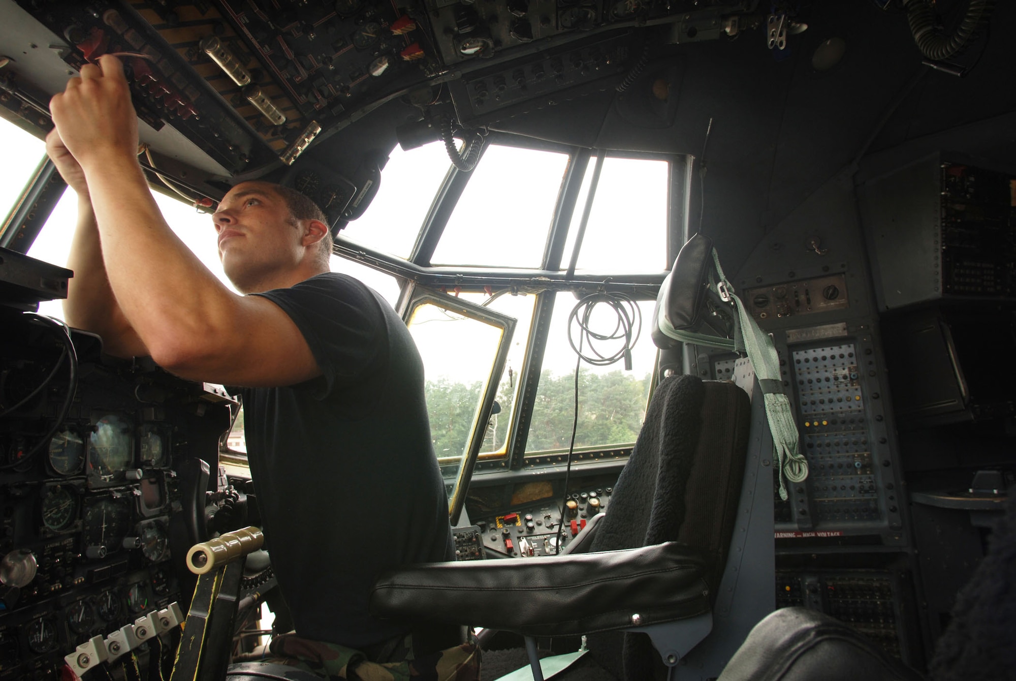 Staff Sgt. Jonathan Weber strings copper safety wire through cockpit control switches June 25 at Ramstein Air Base, Germany. The 47-year-old plane will soon represent the 86th Airlift Wing in the 2007 Air Mobility Command Rodeo at McChord Air Force Base, Wash. Sergeant Weber is a C-130 crew chief assigned to the 86th Aircraft Maintenance Squadron. (U.S. Air Force photo/Master Sgt. Scott Wagers) 
