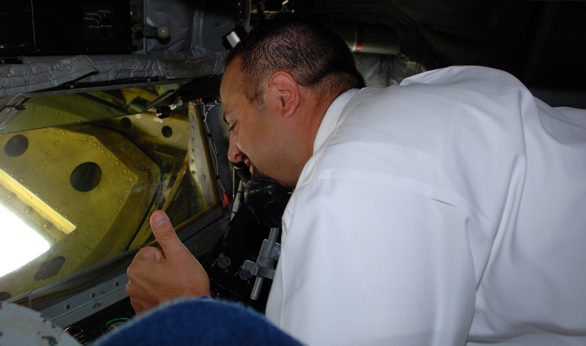Claudio Ferraro, vice president of strategic planning and marketing at Via Christi Hospital and 22nd Medical Group honorary commander gives a thumb-up from the boom pod of a KC-135 Stratotanker static display during an honorary commander’s orientation June 20. The group experienced a day in the life of a McConnell “knucklebuster” by touring several different 22nd MXG workshops. (Photo by Airman 1st Class Jessica Lockoski)