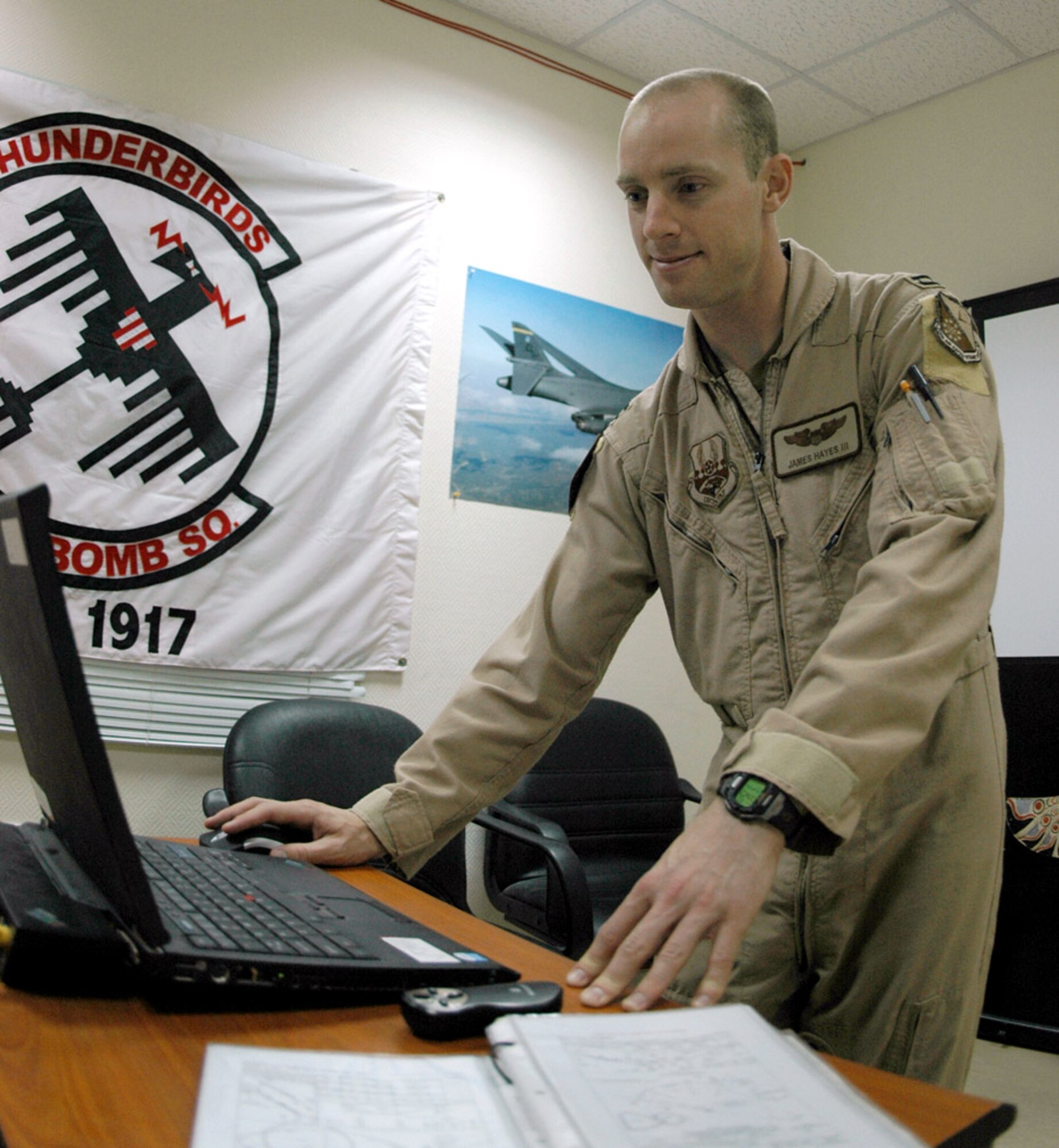 Capt. James Hayes prepares for a close air support mission.  CAS missions require effective communication between air and ground forces.  Captain Hayes is pilot deployed to the 34th Expeditionary Bomb Squadron in Southwest Asia.  (U.S. Air Force photo/Capt. Teresa Sullivan)