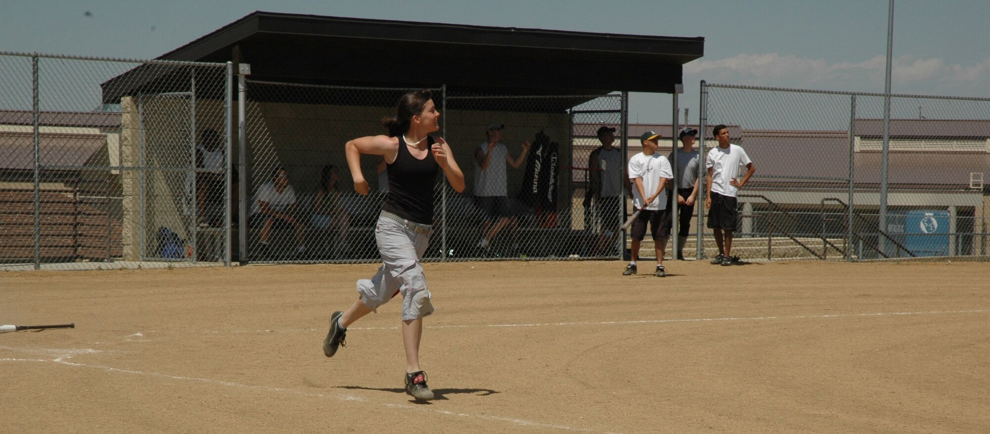 Jolene Bullock takes off from home plate after nailing a softball to left field as the 341st Missile Maintenance Squadron’s team faced off against the 341st Civil Engineer Squadron during the Air Force Ball Association soft ball tournament Satruday. (U.S. Air Force photo / Airman 1st Class Emerald Ralston)