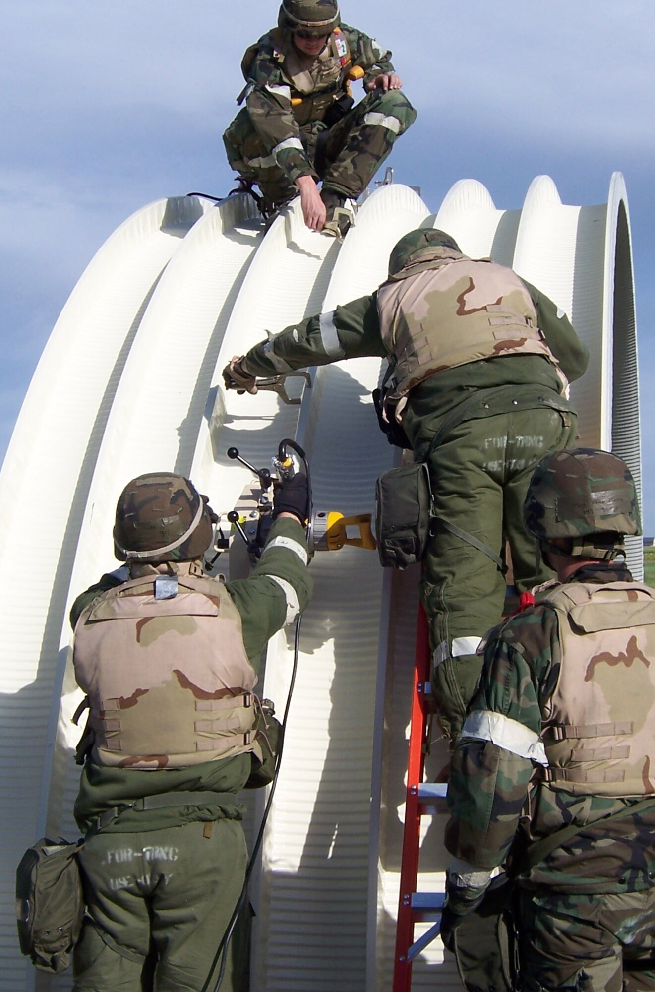 819th RED HORSE team members work together to seam two metal arches to form one section of an expedient build, called a K-span, while Air Combat Command inspectors evaluate them during their Operational Readiness Inspection. (Courtesy photo)