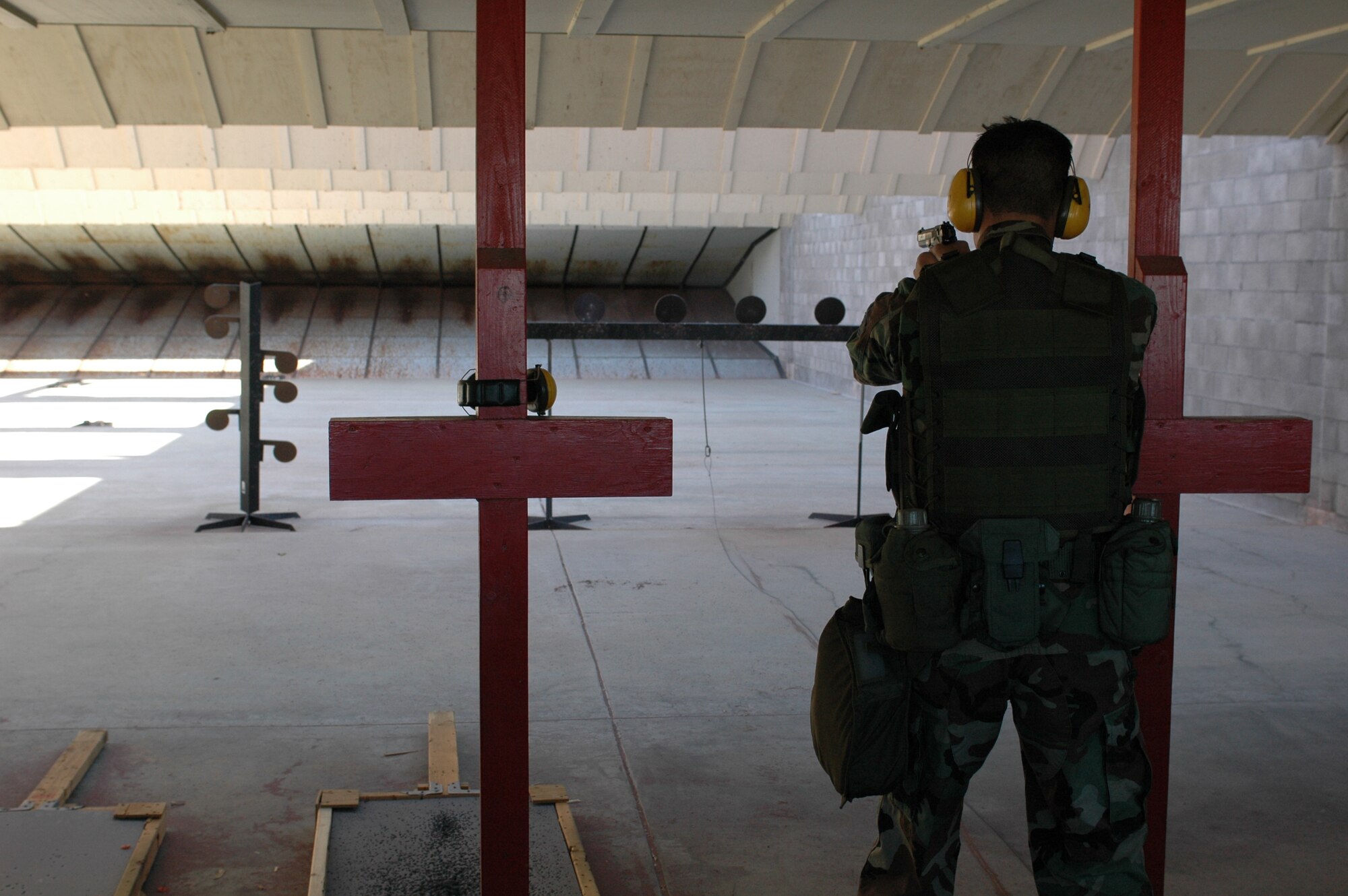 Staff Sgt. Luis Garcia, 60th Security Forces Squadron Rodeo team member, shoots an M-9 handgun during a training exercise June 22. Sergeant Garcia will participate along with two other teammates at the Rodeo Challenge at McChord Air Force Base, Wash. (U.S. Air Force photo by Airman 1st Class Kristen Rohrer)