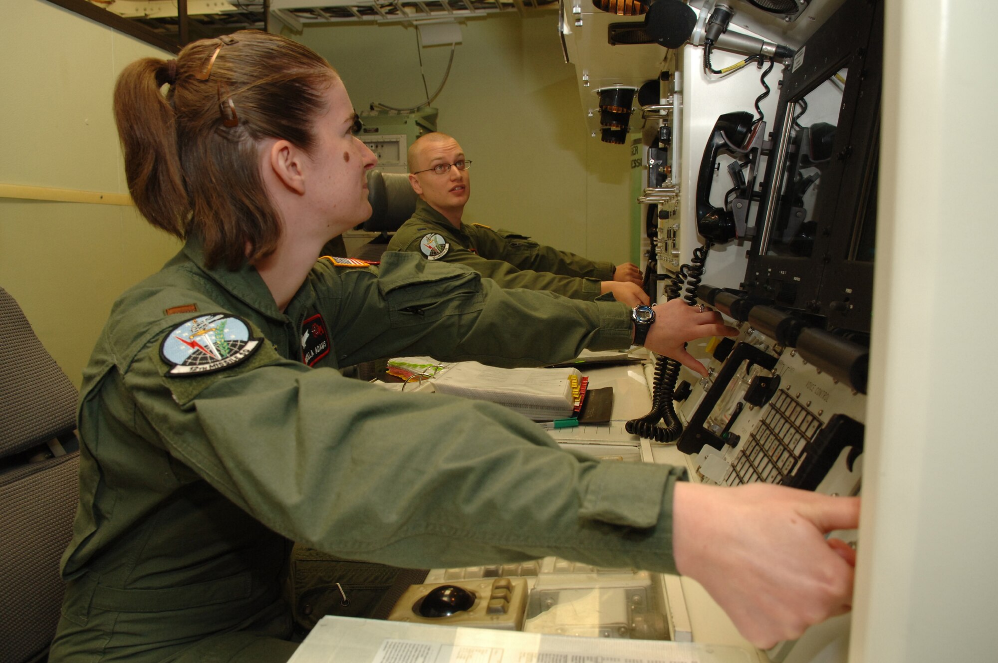 Missile operators follow an inspection script in the missile procedures trainer June 12. All 16 missile combat crews evaluated either met or exceeded standards.  (U.S. Air Force photo/Staff Sgt. Chenzira Mallory)