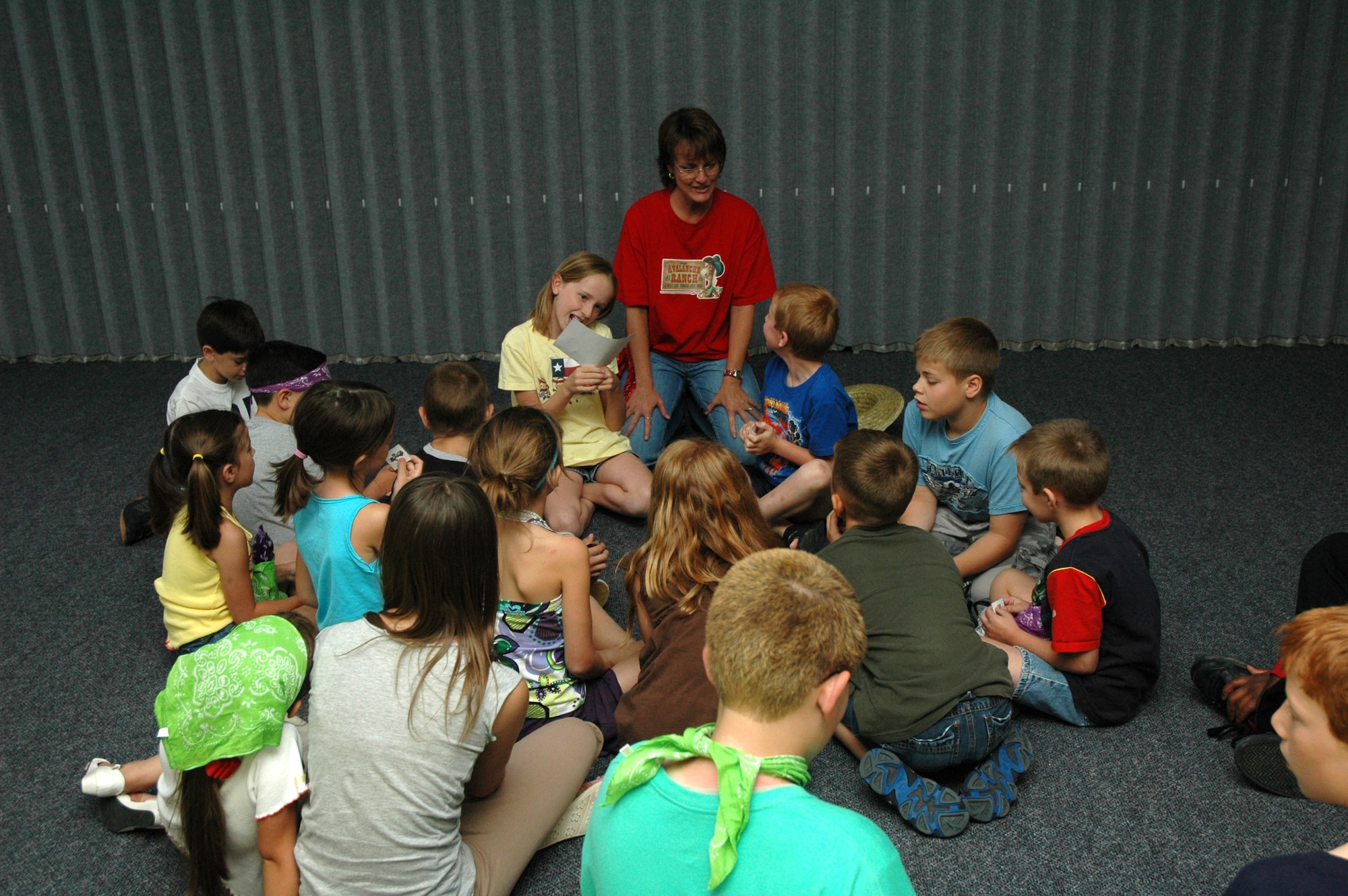 LuAnn Barnes, a volunteer leader for Vacation Bible School at the chapel, leads the Little Warriors in a group discussion.  (U.S. Air Force photo / Airman 1st Class Dillon White)