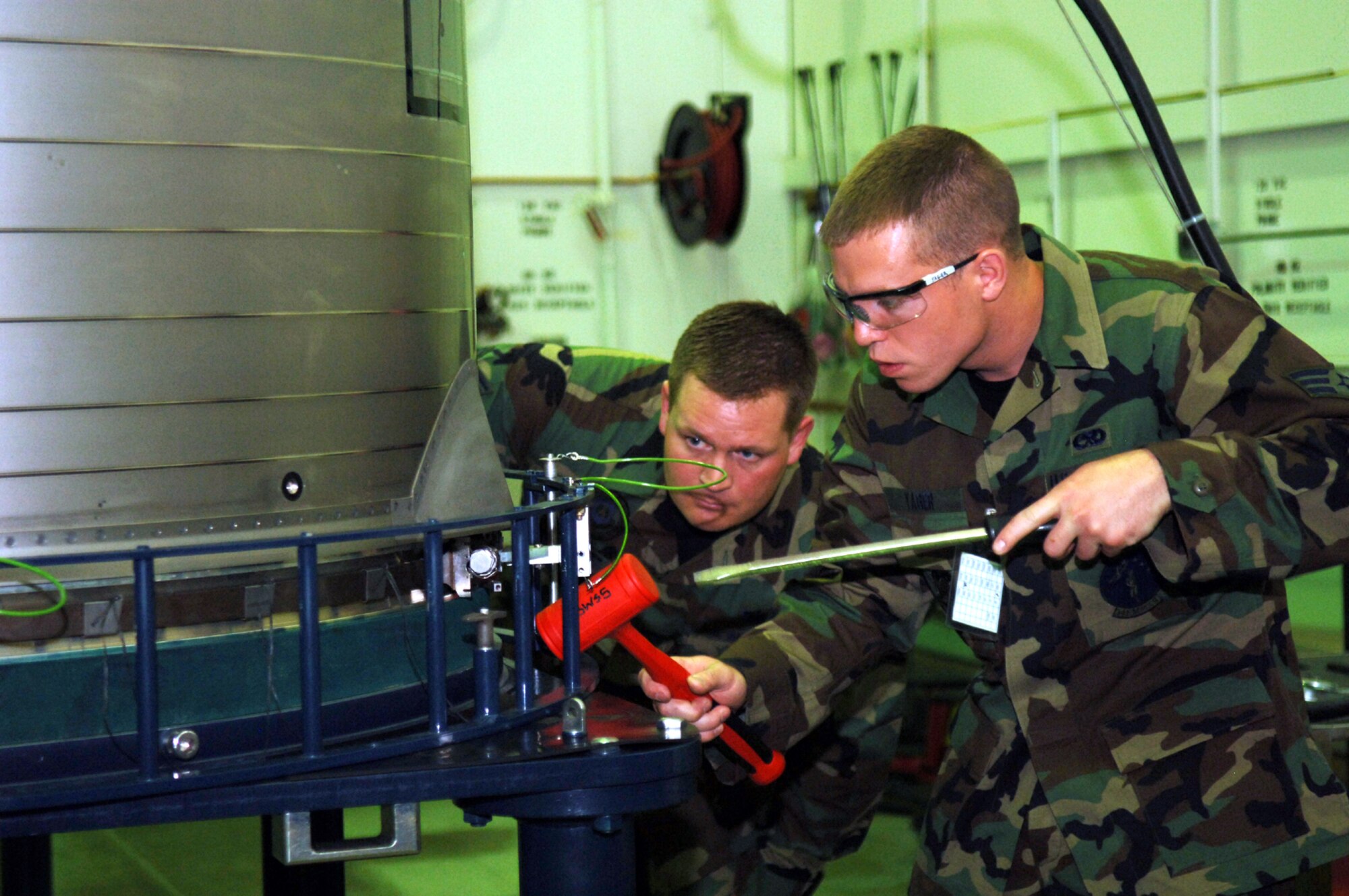 Adhering to the two-person concept, Team Malmstrom missile maintainers carry out the inspector’s instructions in the T-9 training facility June 15. (U.S. Air Force photo/Staff Sgt. Chenzira Mallory)