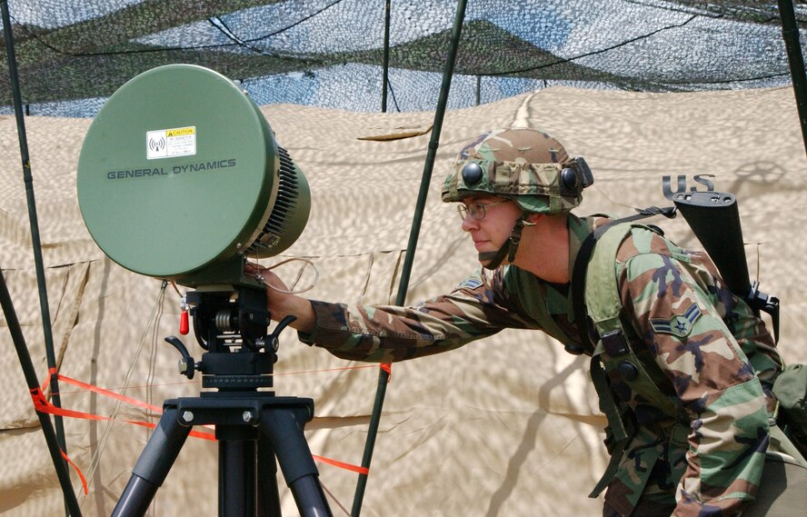 Airman 1st Class David Hill checks a radio frequency transmitter during a United Architecture exercise. Airmen from the U.S. Air Force joined together with servicemembers from the United Kingdom’s Royal Air Force in a field exercise. U. S. Air Force photo by George Jozens     