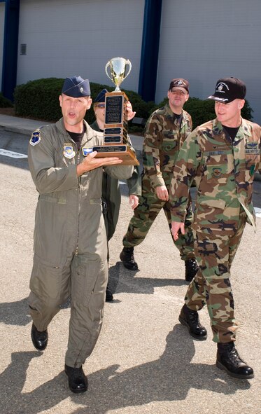 Lt. Col. Blaine Holt, acting commander of the 19th Air Refueling Group hoists their trophy after the 19th ARG was named the 2007 Community Service Award recipient June 21 by the Warner Robins Military Affairs Committee of the Warner Robins Chamber of Commerce. U. S. Air Force photo by Eric Palmer