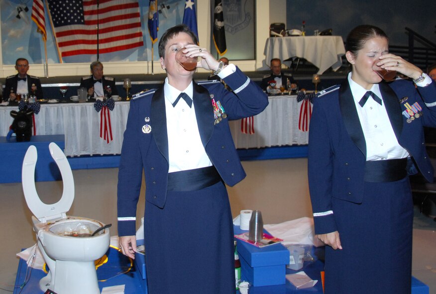 Col. Theresa Carter, 78th ABW commander and Capt. Kay Beigh, 78th ABW executive officer take a swig of the grog. U. S. Air Force photo by Claude Lazzara
