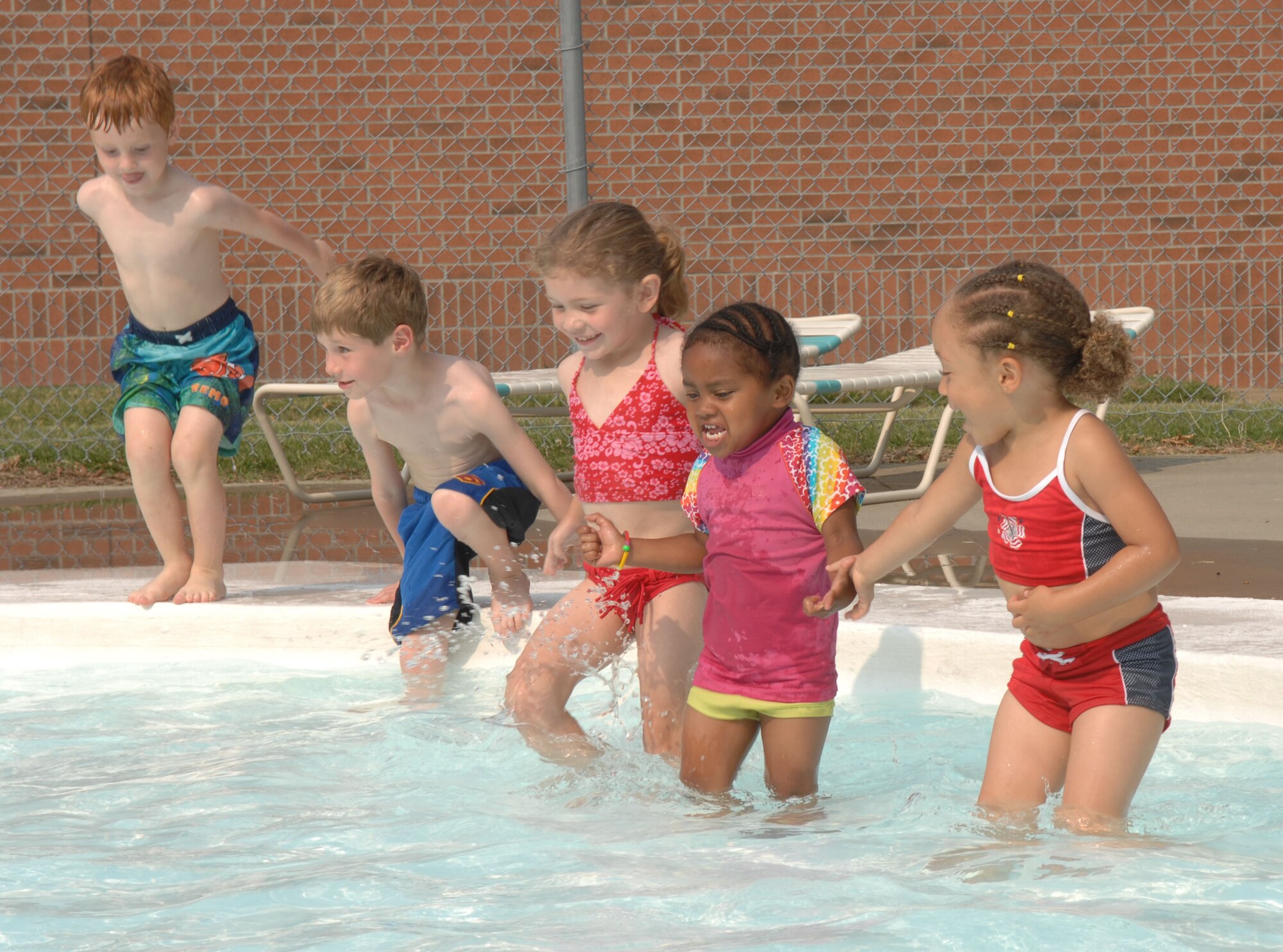 LANGLEY AIR FORCE BASE, Va. -- Preschoolers from the Russ Child Development center cool off at the Shellbank kiddie pool here June 26. Throughout the summer, children at the Russ Child Development Center take a number of field trips around Langley including walks to the bowling center, library, pool, arts and crafts center and Eagle Park. (U.S. Air Force Photo/Senior Airman Tabitha Kuykendall)