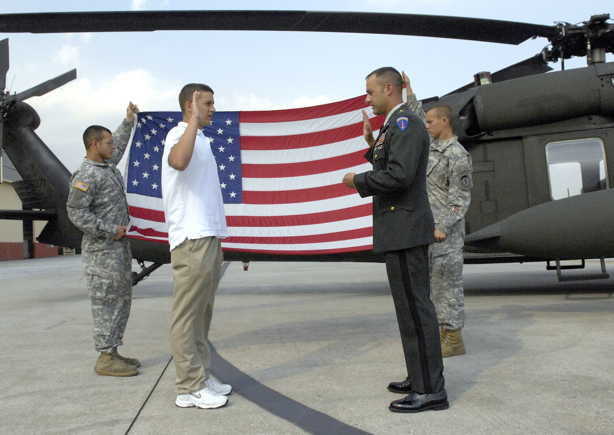 Army Chief Warrant Officer Ronald Wagner (right) enlists his 18-year-old son Devin into the Army infantry June 22. (U.S. Air Force photo by Airman 1st Class Michael Dorus)
