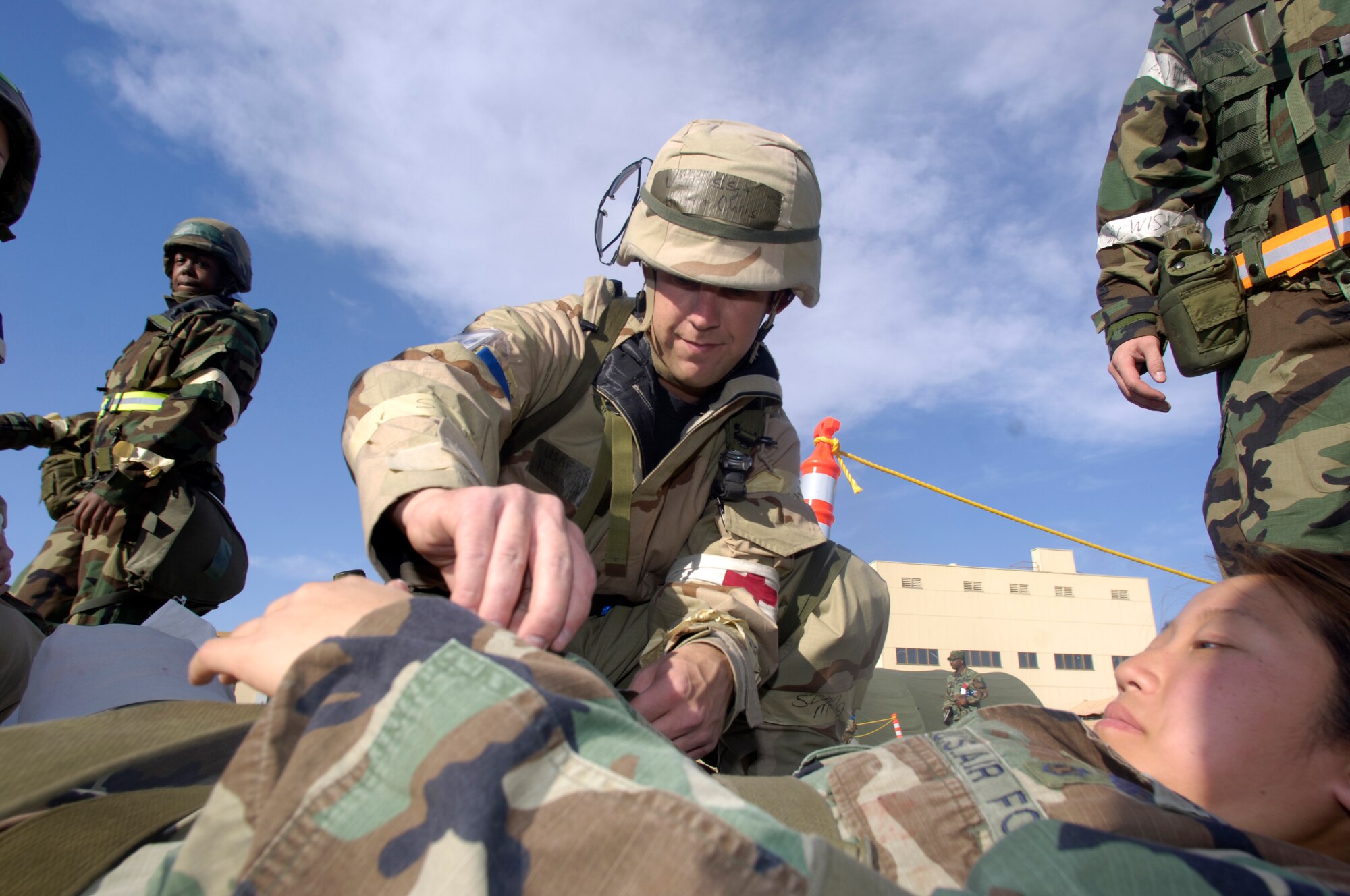 Staff Sgt. Chris Hinton, 366th Medical Support Squadron, checks a victim for any hidden weapons or explosives before moving her into a medical tent June 27.  The 366th Fighter Wing is currently conducting a phase two exercise in which the whole base participates, so Airmen will be prepared for war. (U.S. Air Force photo/Airman 1st Class Ryan Crane) 
