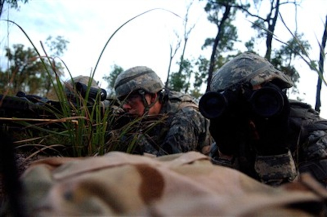 U.S. Army Pvt. William Whittaker scans the horizon for opposing forces with his binoculars during exercise Talisman Sabre 2007 in Shoalwater Bay, Australia, June 24, 2007. The biennial exercise is designed to train Australian and U.S. forces in planning and conducting combined task force operations.