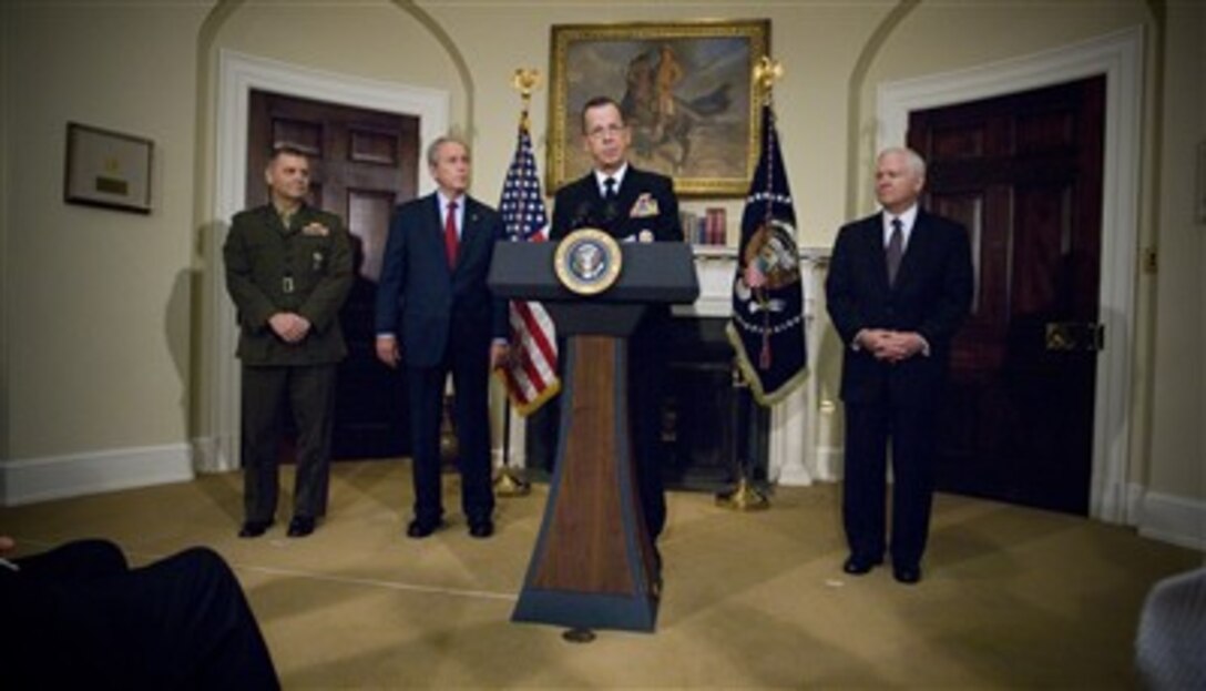 Chief of Naval Operations Adm. Mike Mullen responds to President Bush's announcement of Mullen to be the next chairman of the Joint Chiefs of Staff. Marine Gen. James E. Cartwright (left), currently the commander of United States Strategic Command, is Bush's nominee for vice chairman. Defense Secretary Robert M. Gates looks on at right, in the Roosevelt Room at the White House, June 28, 2007. 