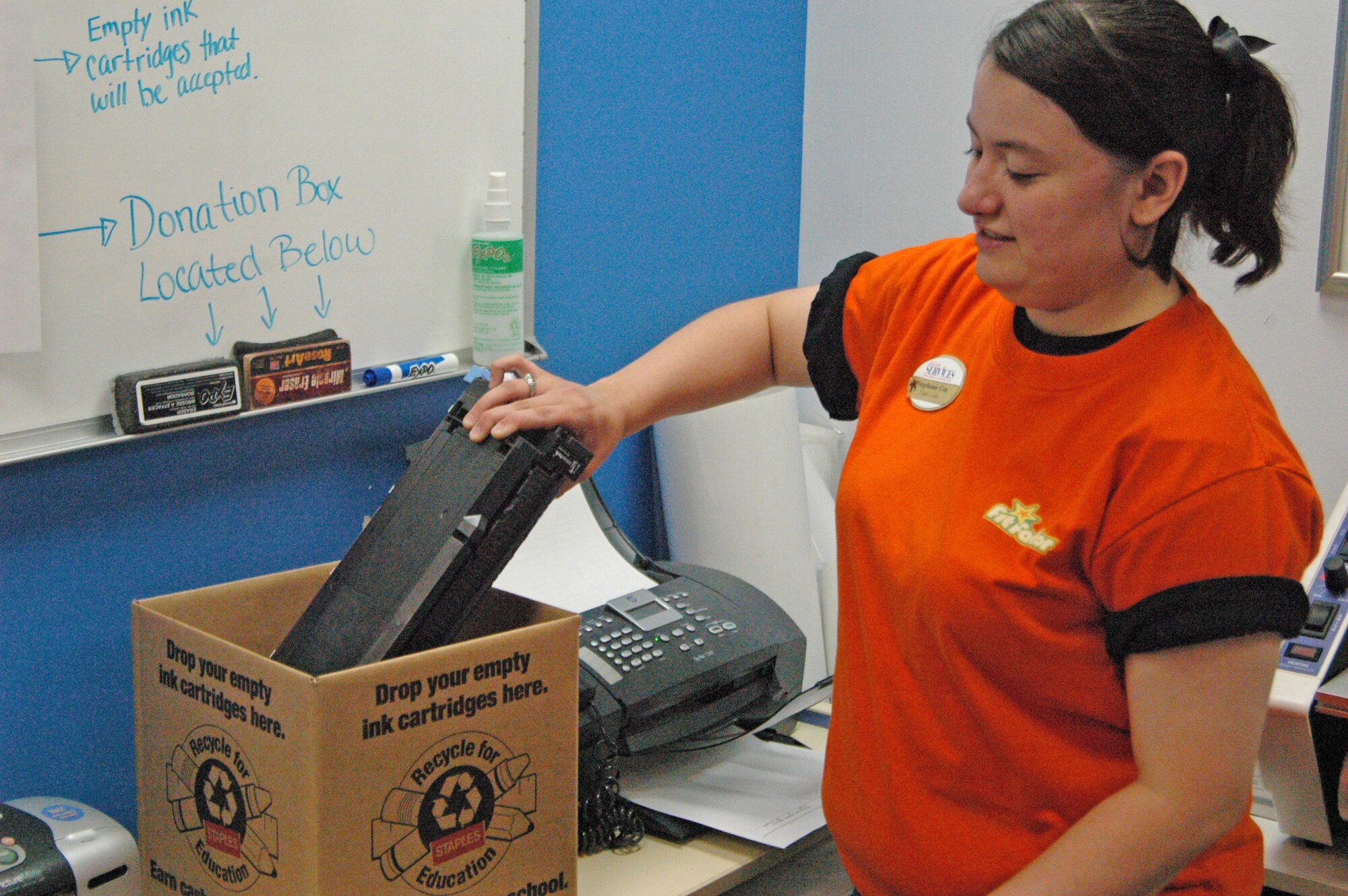 EIELSON AIR FORCE BASE, Alaska--Stephanie Cox, youth center program coordinator, receives a donated ink cartridge June 29 at the youth center. The Boys and Girls Clubs of America, operate through the youth center the torch club, which takes donated printer cartridges and recycles them for money. Each cartridge is worth about $3 which is used towards youth activities. (U.S. Air Force photo by Cadet 2nd Class Kate Staples)