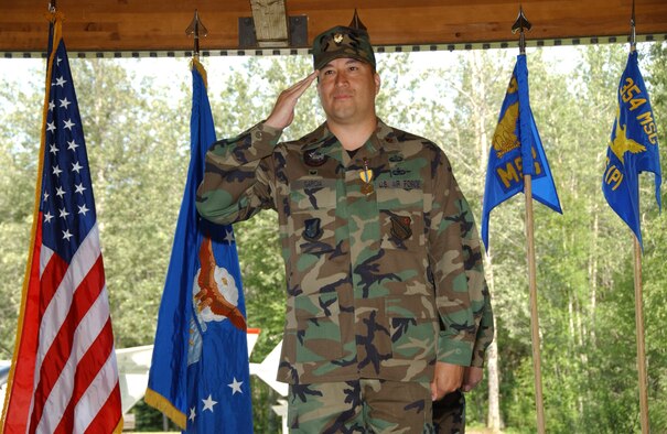 EIELSON AIR FORCE BASE, Alaska -- Maj. Alex Garcia, 354th Force Support Squadron, renders a final salute to the 354th Services Squadron June 27 here. There are currently only six bases under structure of merging their Mission Support Squadrons and Services Squadrons into a Force Support Squadron; Eielson is the only one in Pacific Air Forces and is also the first to hold a change of command ceremony for this squadron. (U.S. Air Force photo by Airman 1st Class Christopher Griffin)