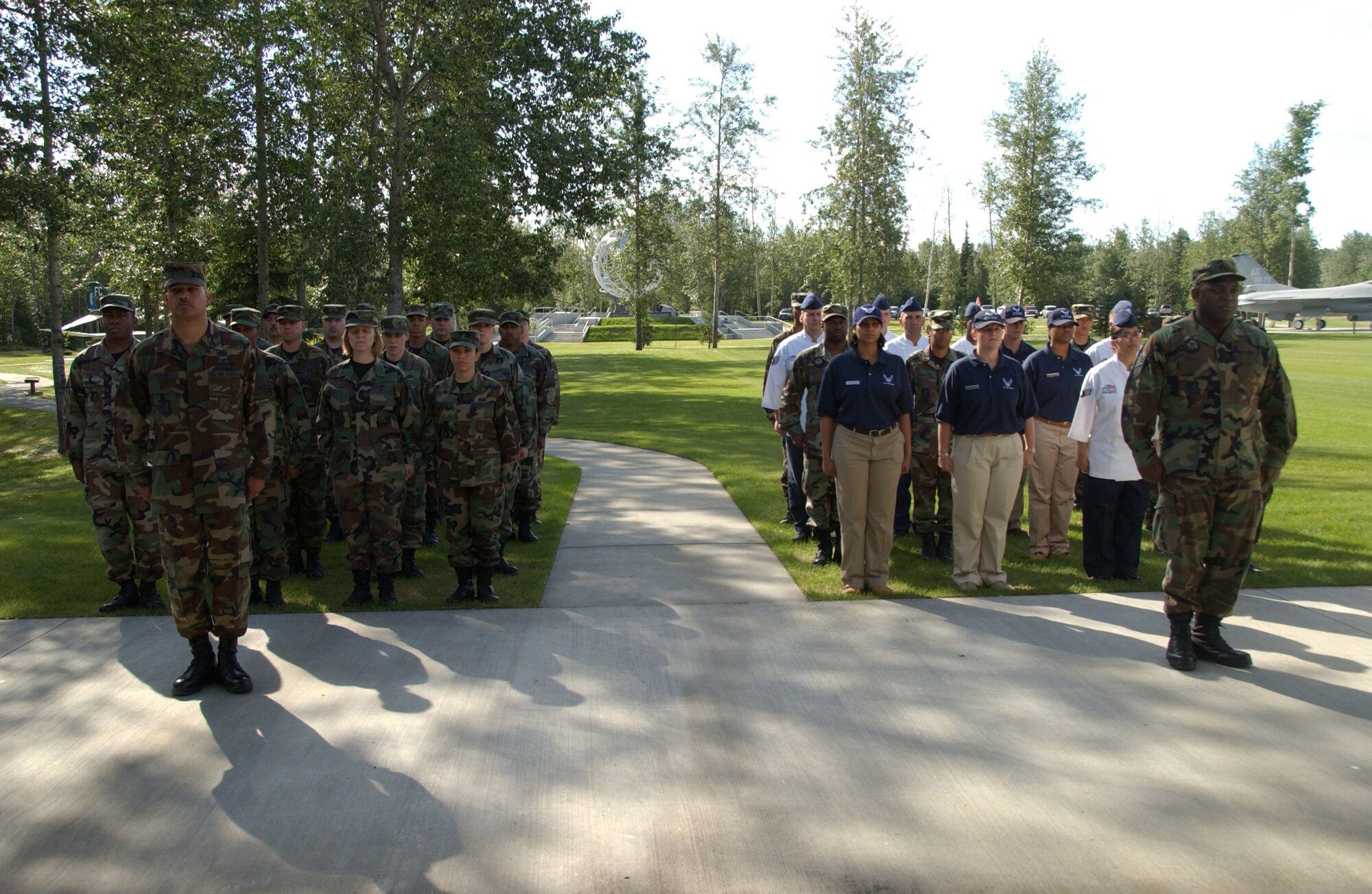 EIELSON AIR FORCE BASE, Alaska -- The Eielson 354th Mission Support Squadron and 354th Services Squadron stand at attention during the change of command ceremony for the merge into the Force Support Squadron June 27 here.  There are currently only six bases under structure of merging their Mission Support Squadrons and Services Squadrons into a Force Support Squadron; Eielson being the only one in the Pacific Air Forces and the first to hold a change of command ceremony for this squadron.   (U.S. Air Force photo by Airman 1st Class Christopher Griffin)
