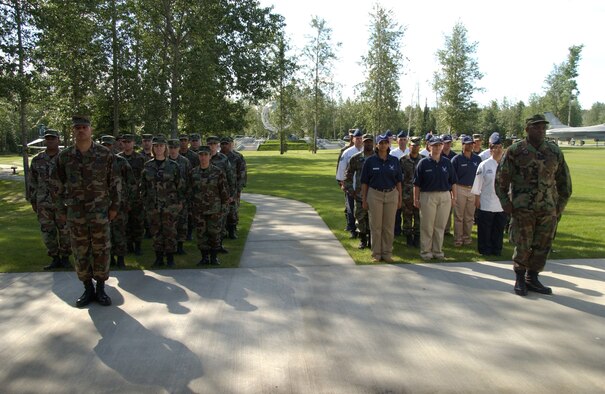 EIELSON AIR FORCE BASE, Alaska -- The Eielson 354th Mission Support Squadron and 354th Services Squadron stand at attention during the change of command ceremony for the merge into the Force Support Squadron June 27 here. There are currently only six bases under structure of merging their Mission Support Squadrons and Services Squadrons into a Force Support Squadron; Eielson is the only one in Pacific Air Forces and is also the first to hold a change of command ceremony for this squadron. (U.S. Air Force photo by Airman 1st Class Christopher Griffin)
